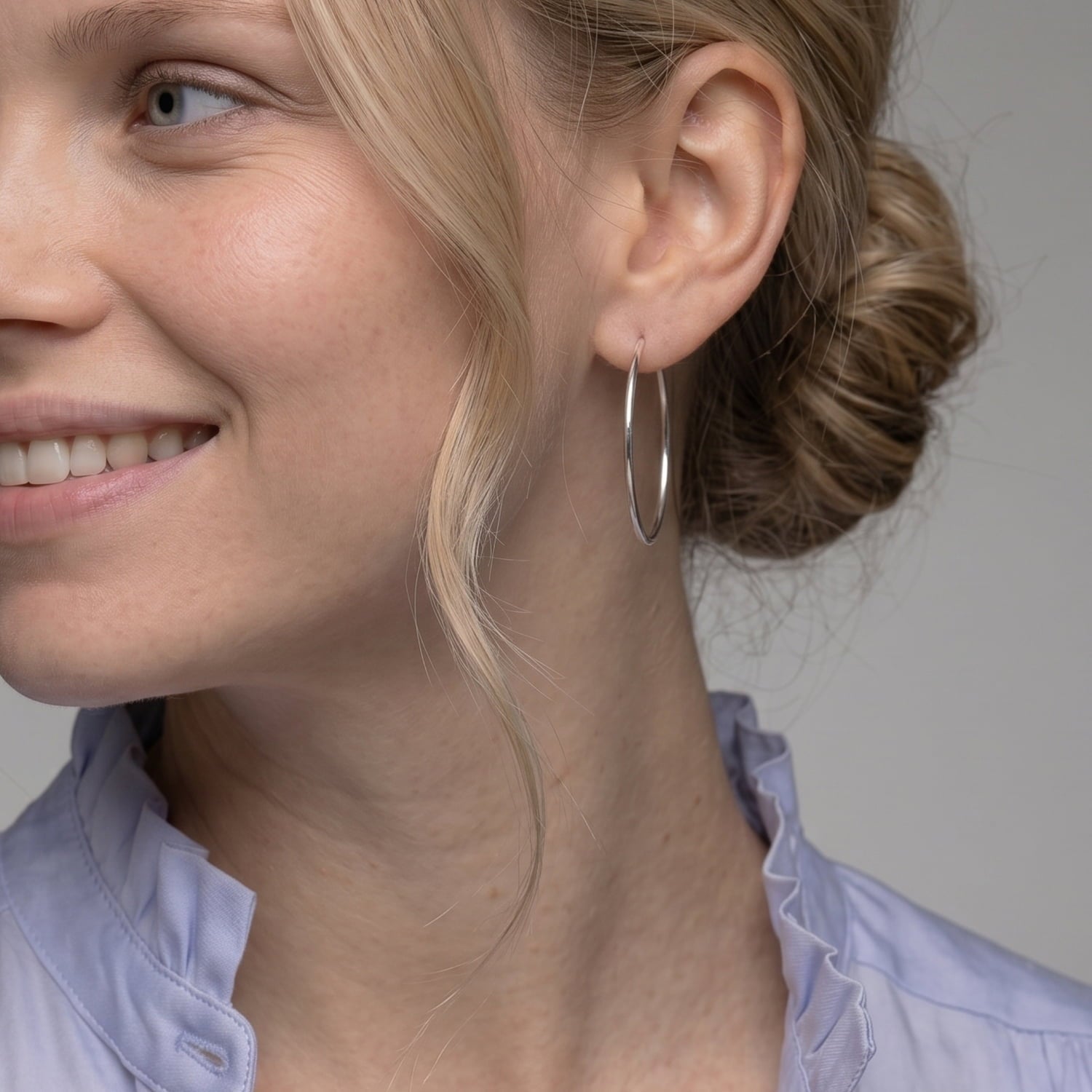 Sleek sterling silver hoop earrings measuring 4cm in diameter with a smooth polished finish, showcasing a timeless, minimalist design in fine British silver jewellery.