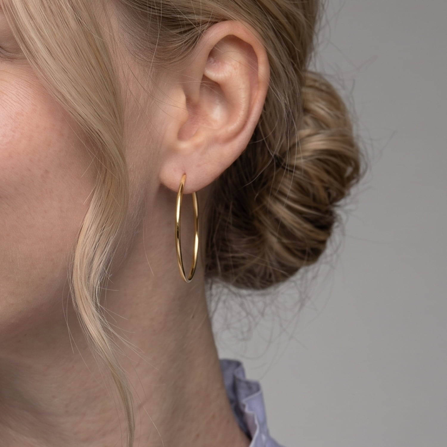Sleek gold vermeil hoop earrings measuring 4cm in diameter with a smooth polished finish, showcasing a timeless, minimalist design in fine British silver jewellery.