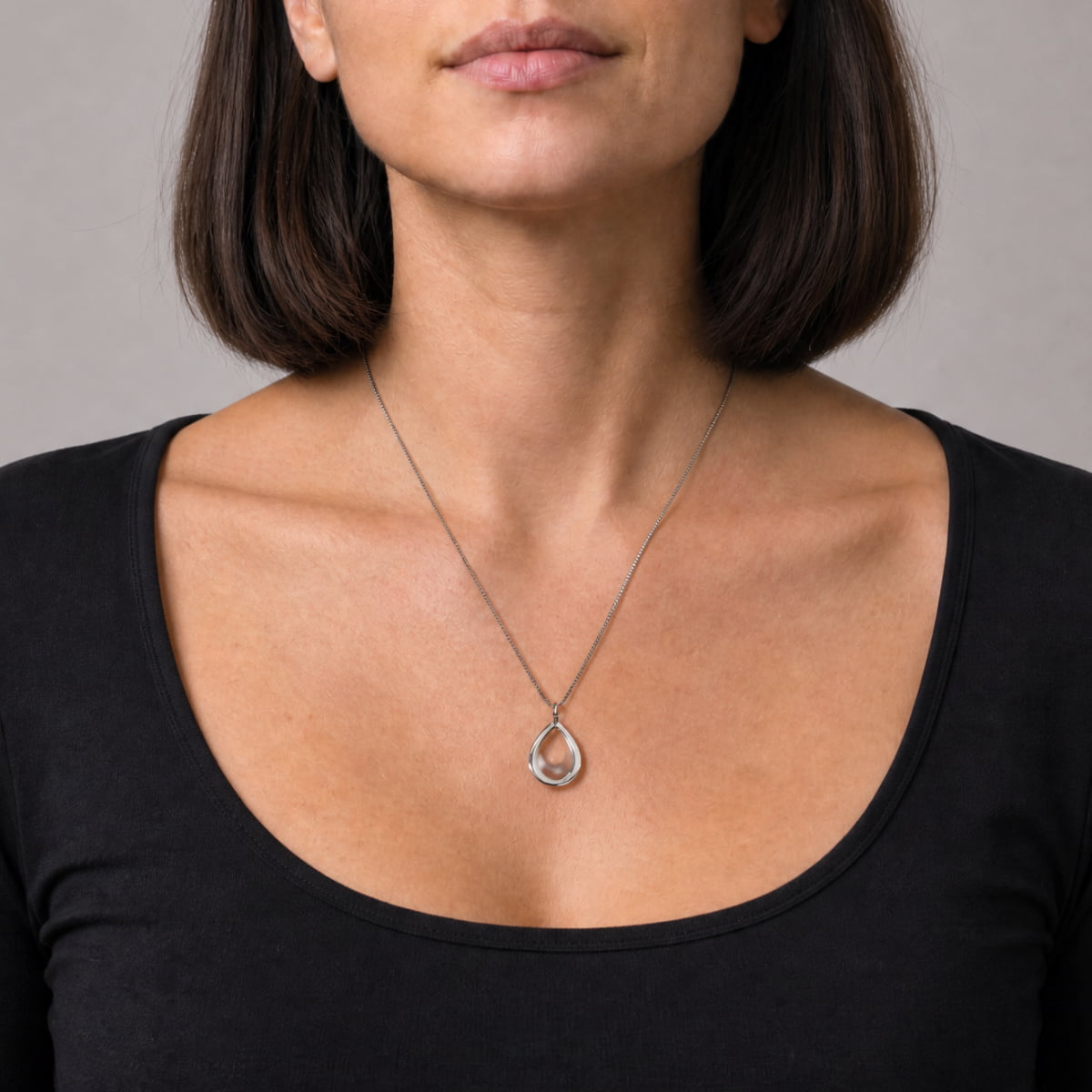 Sleek sterling silver teardrop pendant with a polished finish, suspended from a delicate chain, showcasing minimalist and timeless design in contemporary silver jewellery.
