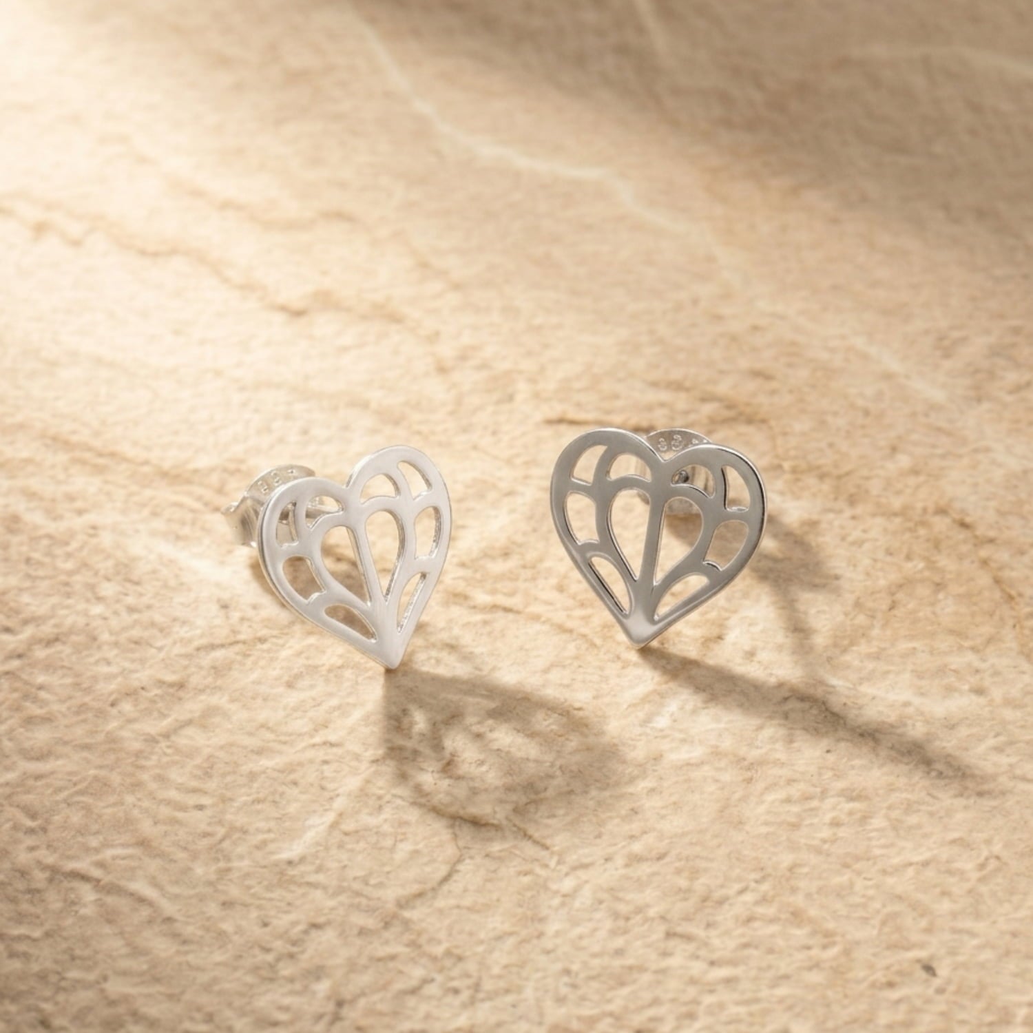 Pair of sterling silver stud earrings featuring a delicate openwork heart design inspired by Yorkshire, showcasing refined craftsmanship in a contemporary silhouette.