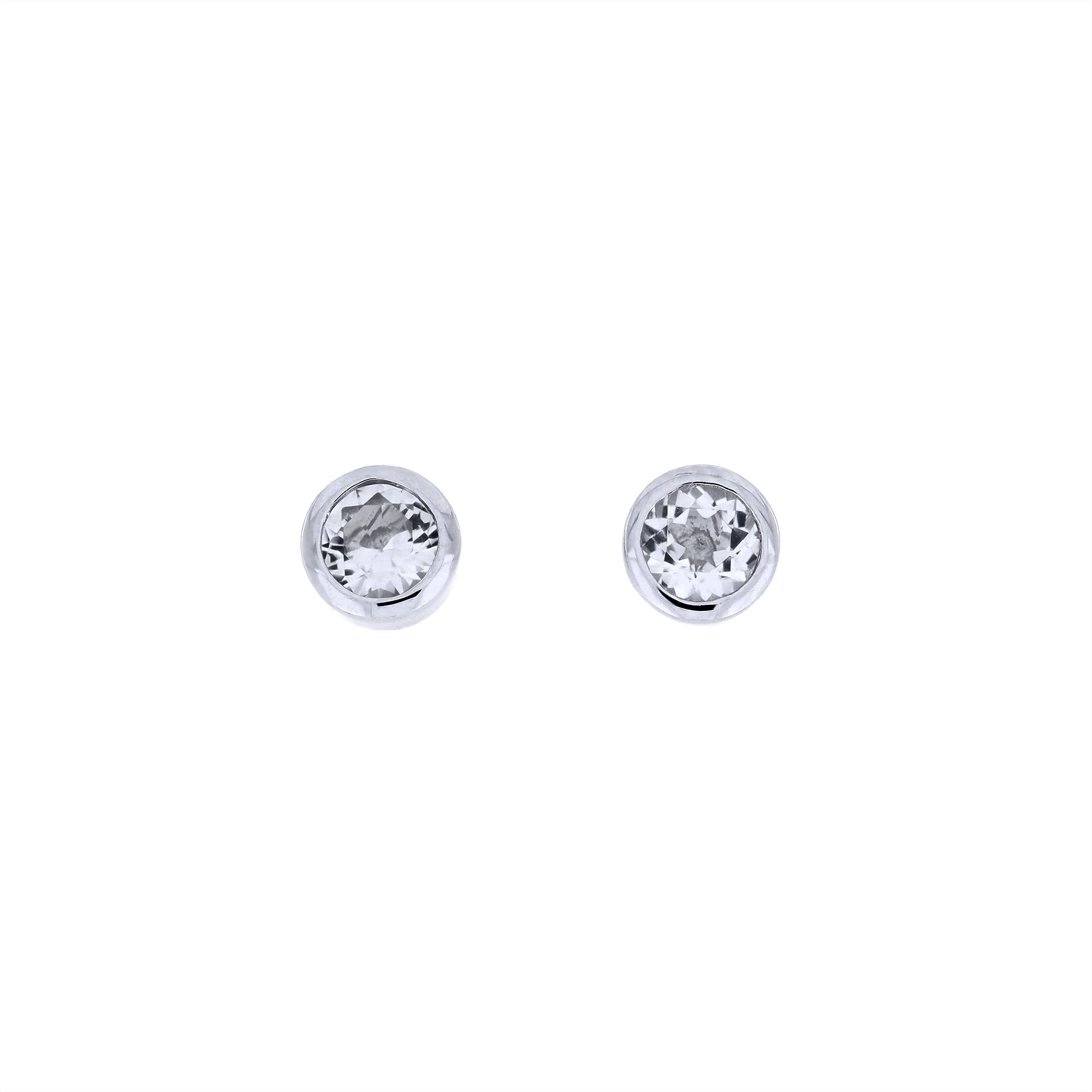 Pair of sterling silver stud earrings featuring sparkling white topaz gemstones in a refined bezel setting, showcasing expert British