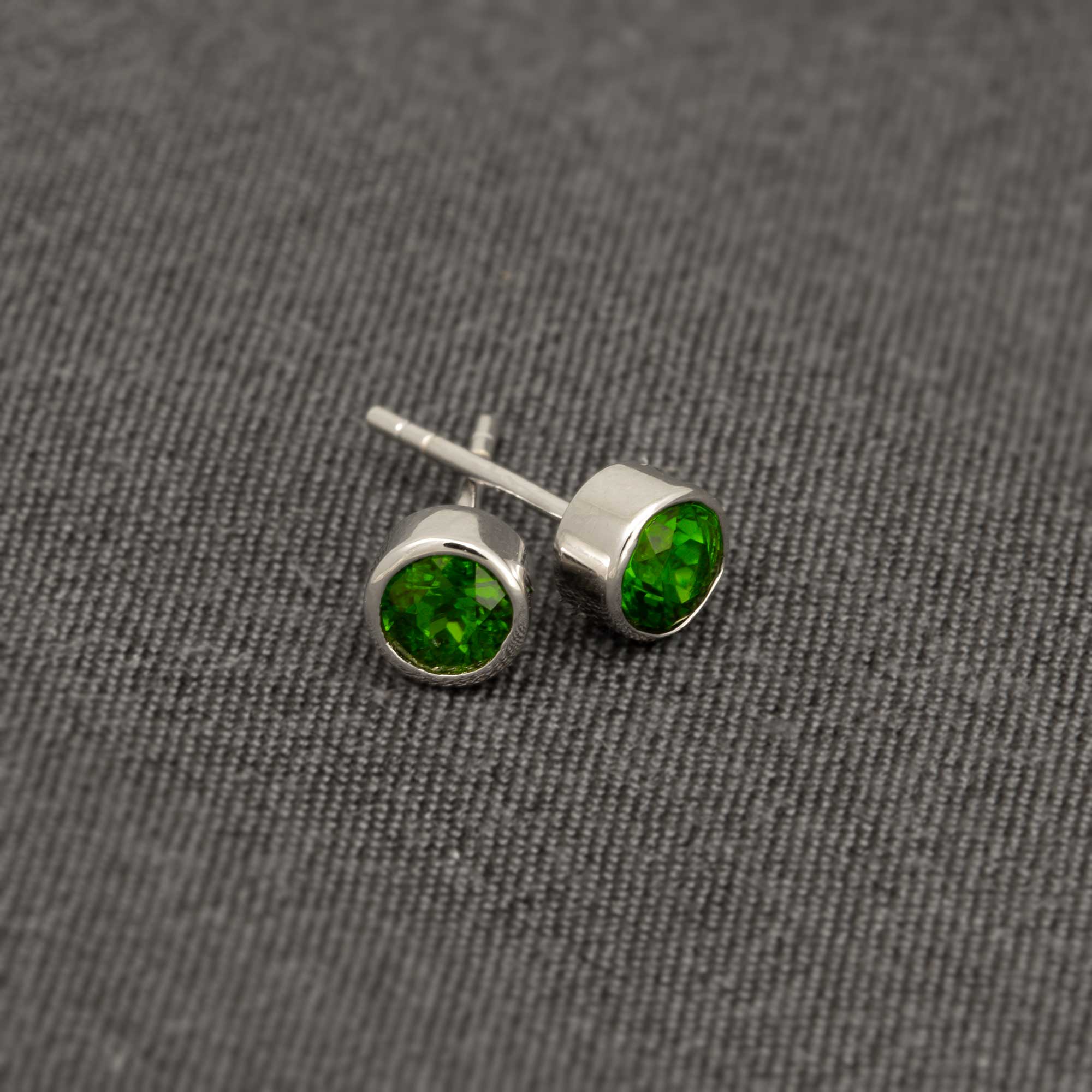 Pair of sterling silver stud earrings featuring vibrant Siberian Emerald gemstones, showcasing a sleek, minimalist design with expert British craftsmanship.