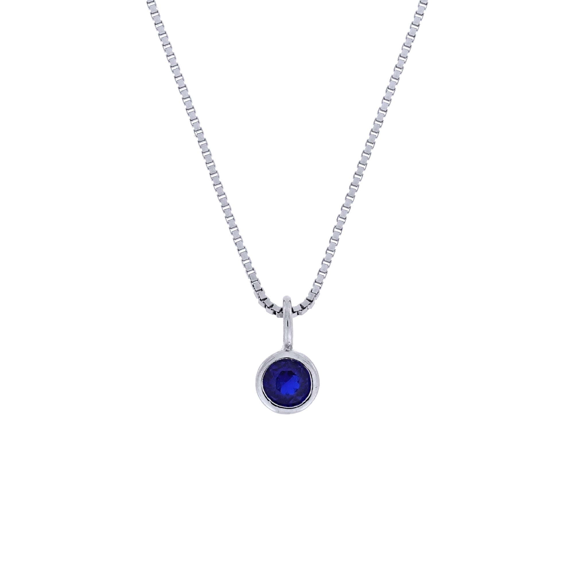 Elegant sterling silver pendant showcasing a deep blue spinel gemstone, suspended on a refined box chain, exemplifying expert British craftsmanship by Azendi.