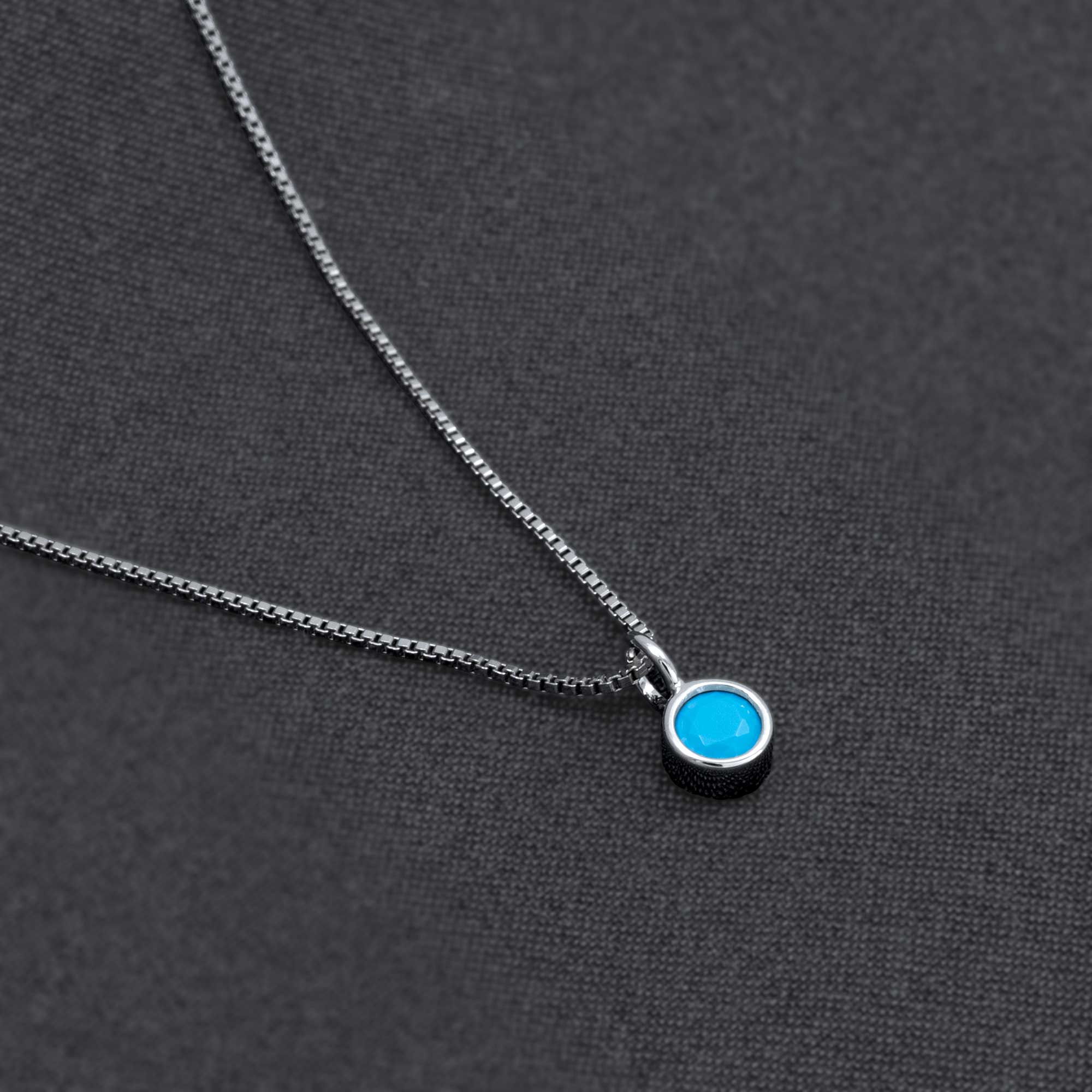 Sterling silver necklace featuring a vibrant turquoise gemstone pendant, showcasing a modern and elegant design by expert British craftsmanship.