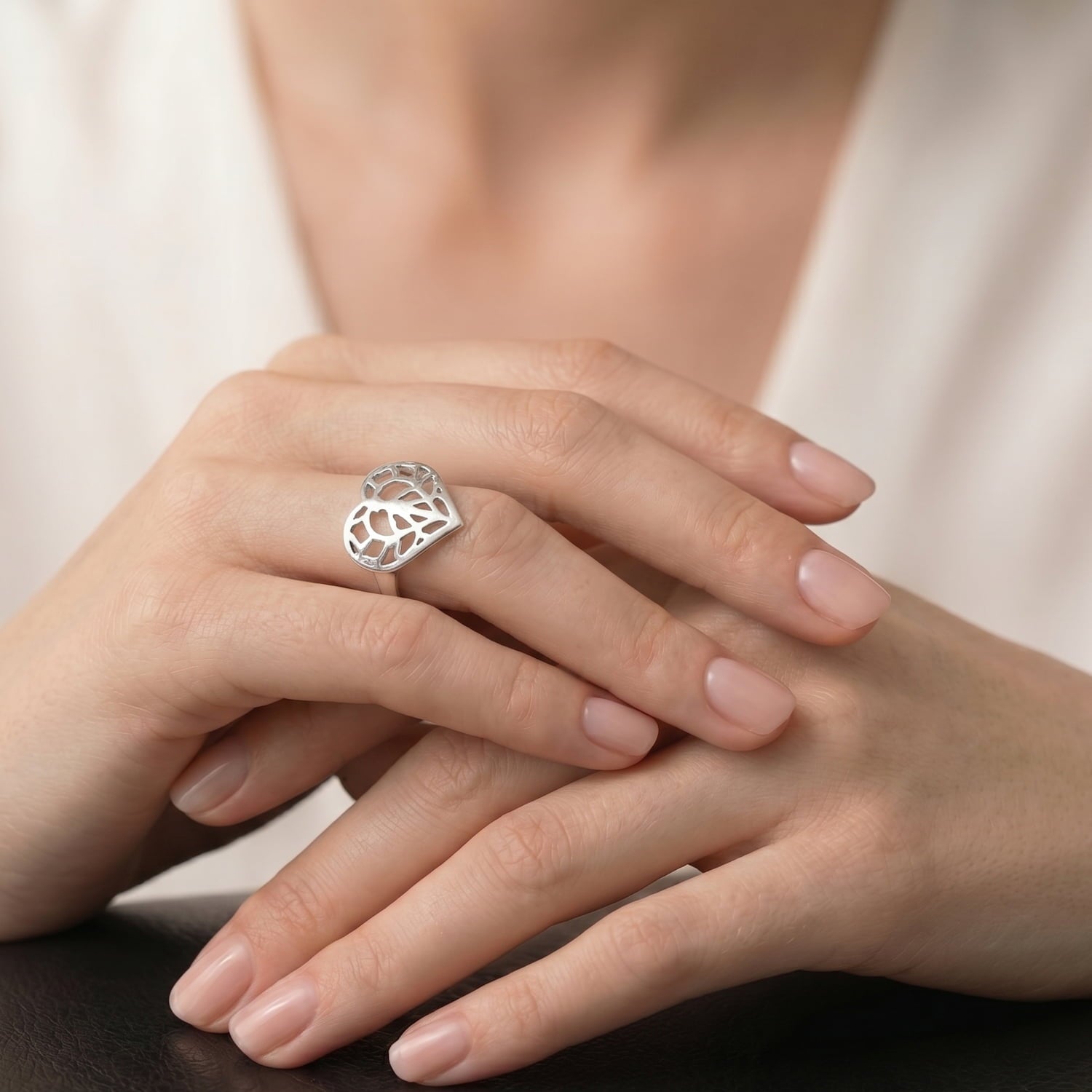 Sterling silver ring featuring a sculptural openwork heart inspired by Yorkshire, worn on a hand with a smooth band, showcasing expert British craftsmanship.