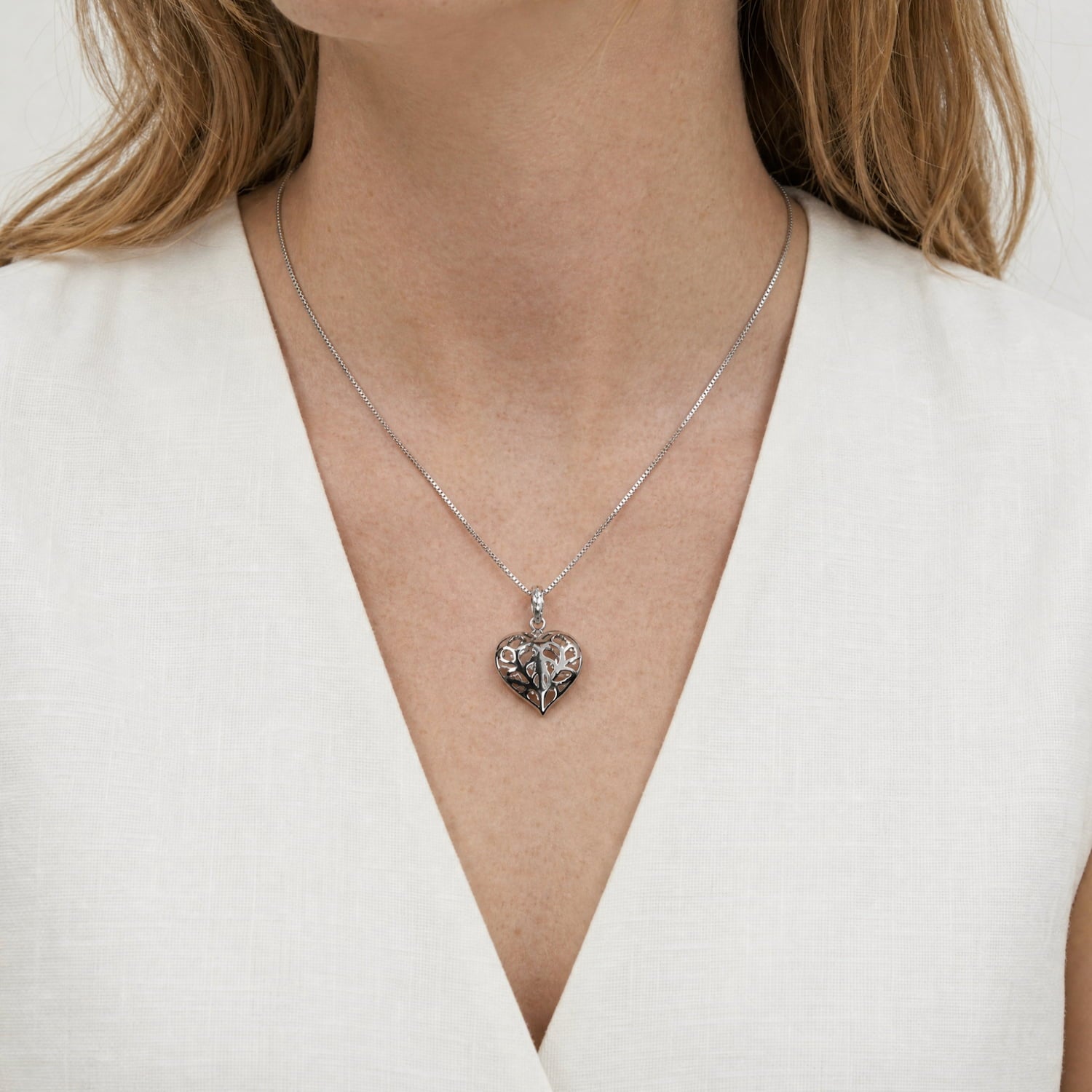 Sterling silver pendant featuring an openwork heart design inspired by York Minster, suspended from a fine chain, showcasing intricate craftsmanship in silver jewellery.