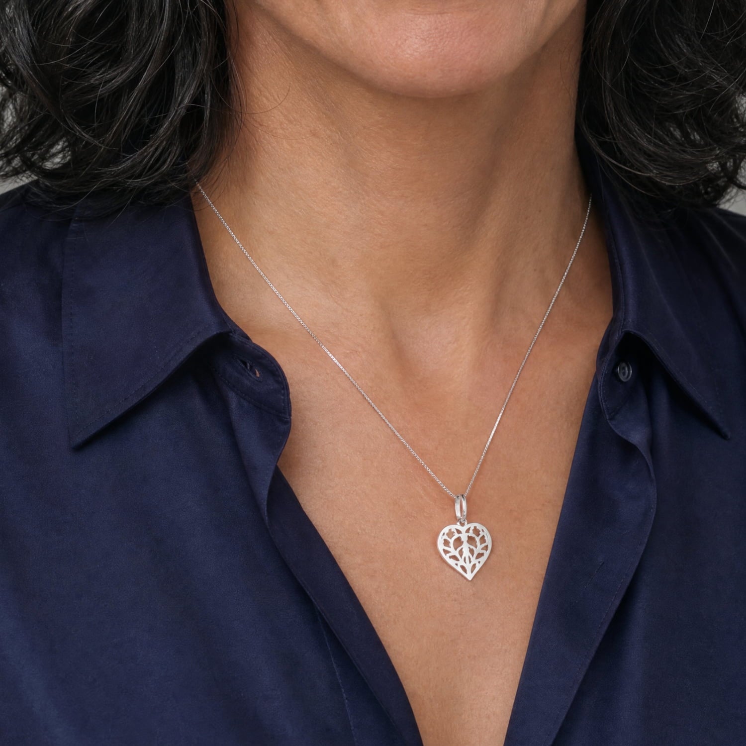 9 carat white gold pendant in a delicate heart shape featuring an openwork design inspired by York Minster, suspended from a fine chain for elegant contemporary jewellery.