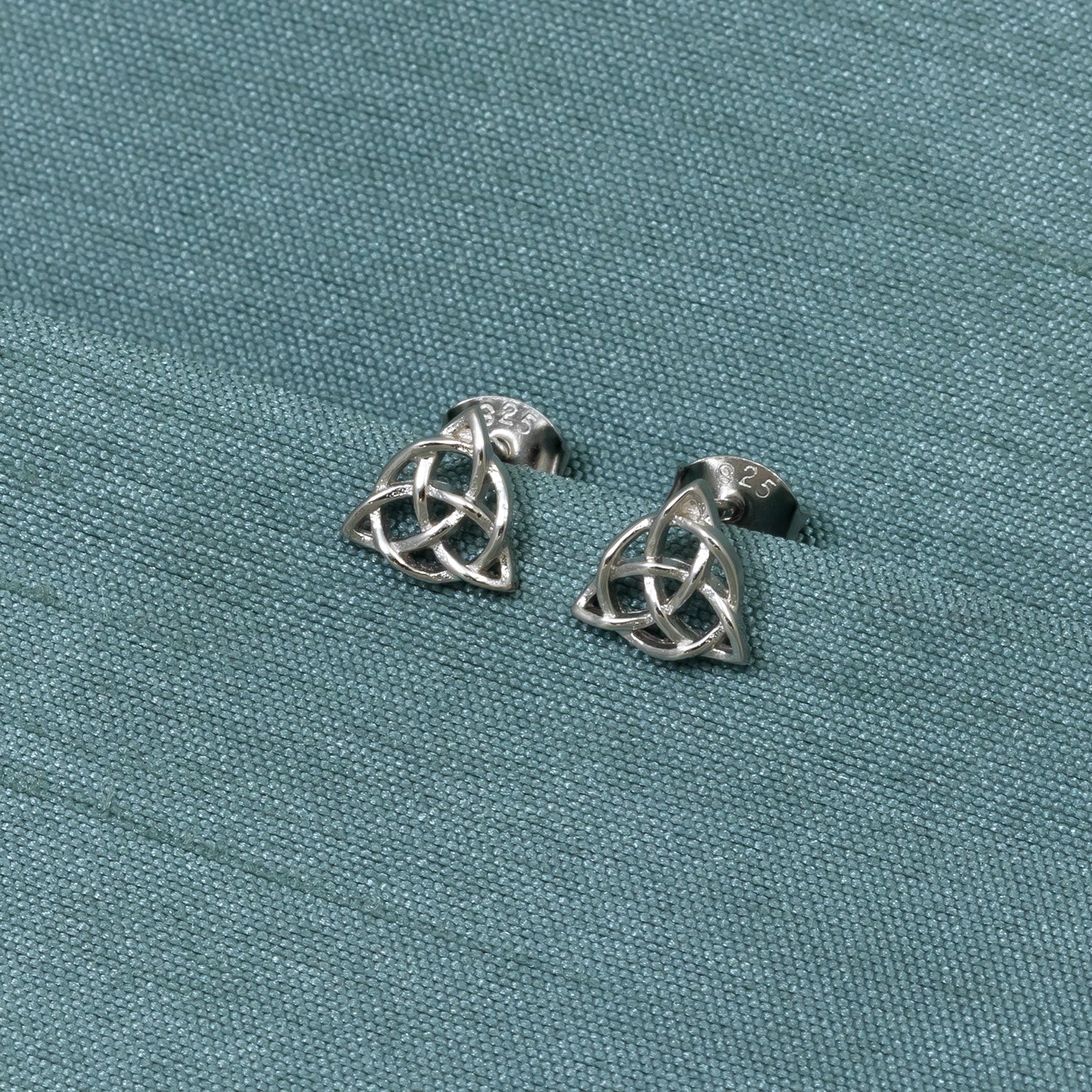 Pair of sterling silver stud earrings featuring intricately crafted Celtic trinity knot design, showcasing expert British jewellery artistry with a polished finish.