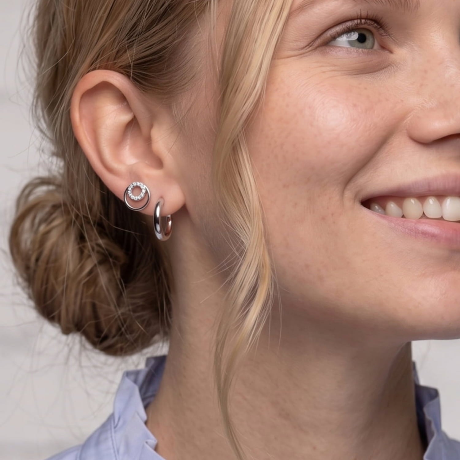 Close-up of a woman wearing silver and cubic zirconia doubloe circle stud earrings