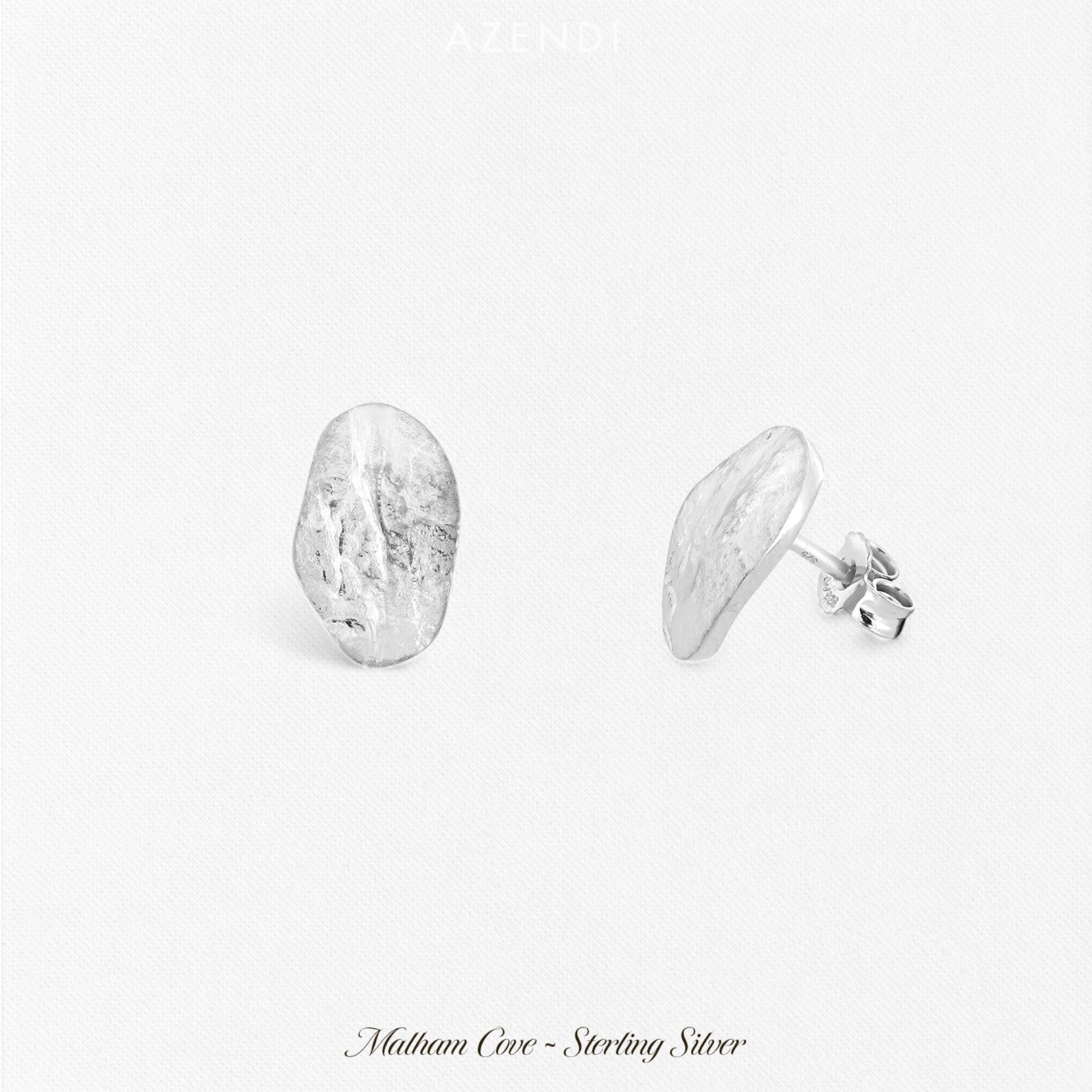 Pair of sterling silver oval stud earrings with a textured, sculptural surface, showcasing a unique, organic design in contemporary silver jewellery by Azendi.
