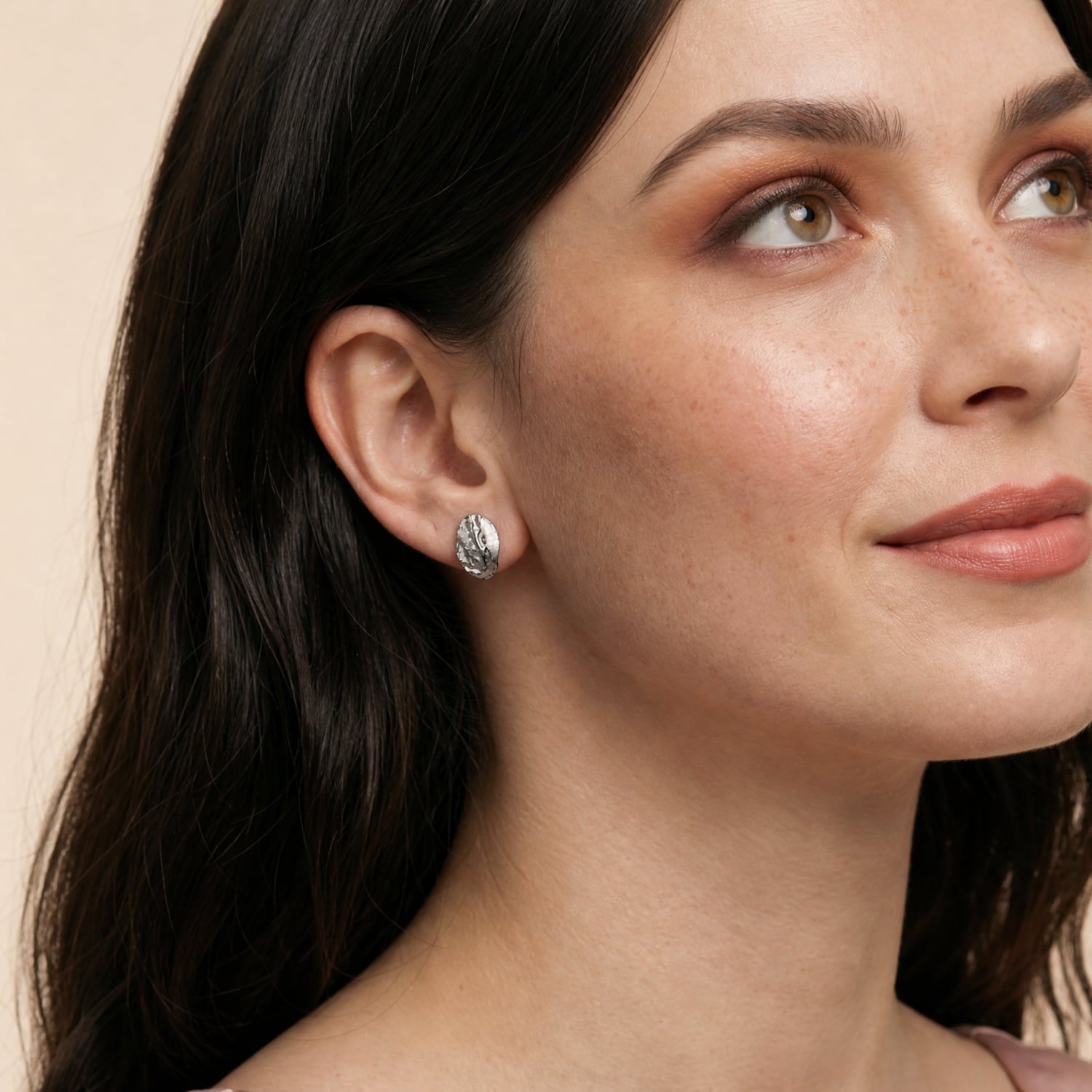Sculptural sterling silver oval stud earrings featuring an organic, textured surface for a refined and contemporary look in British sterling silver jewellery by Azendi.