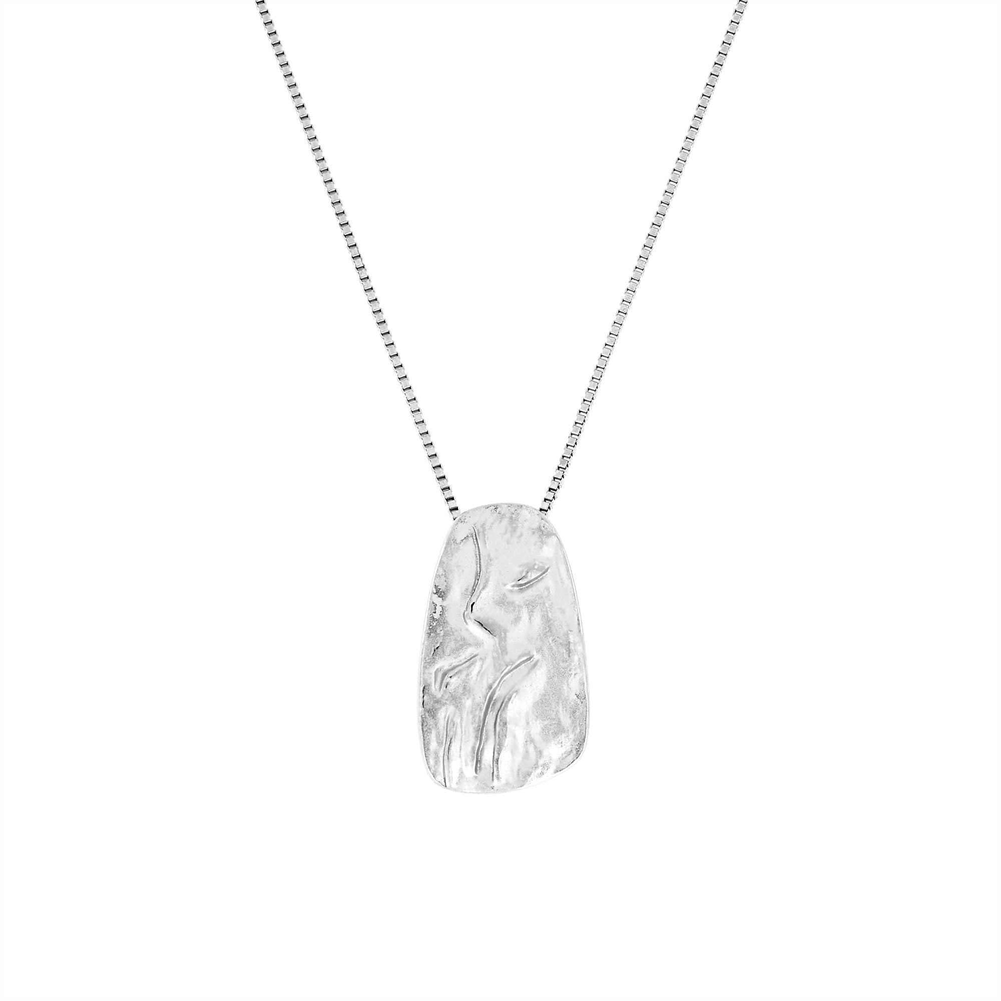 Sculptural sterling silver pendant inspired by natural pebbles, suspended on a fine polished chain, showcasing a minimalist design with contemporary British silver craftsmanship.