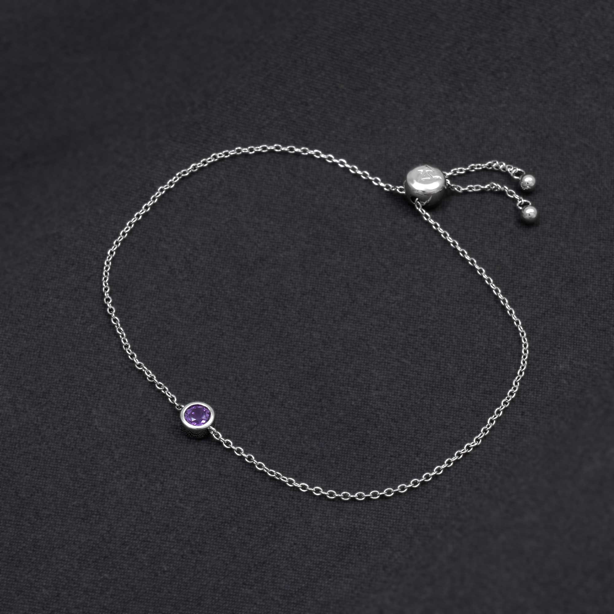 Delicate sterling silver bracelet featuring a bezel-set amethyst stone with a sliding adjuster, exemplifying minimalist design and expert British craftsmanship.