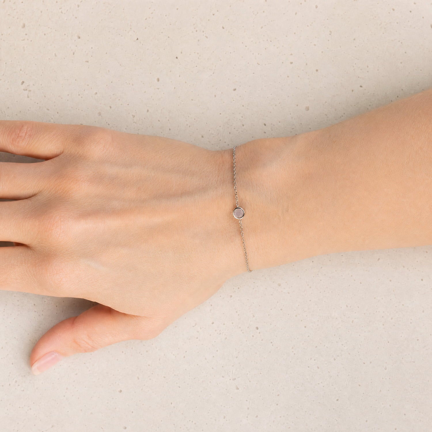 Delicate sterling silver bracelet featuring a small aqua chalcedony gemstone set on a fine adjustable chain, exemplifying refined British craftsmanship.