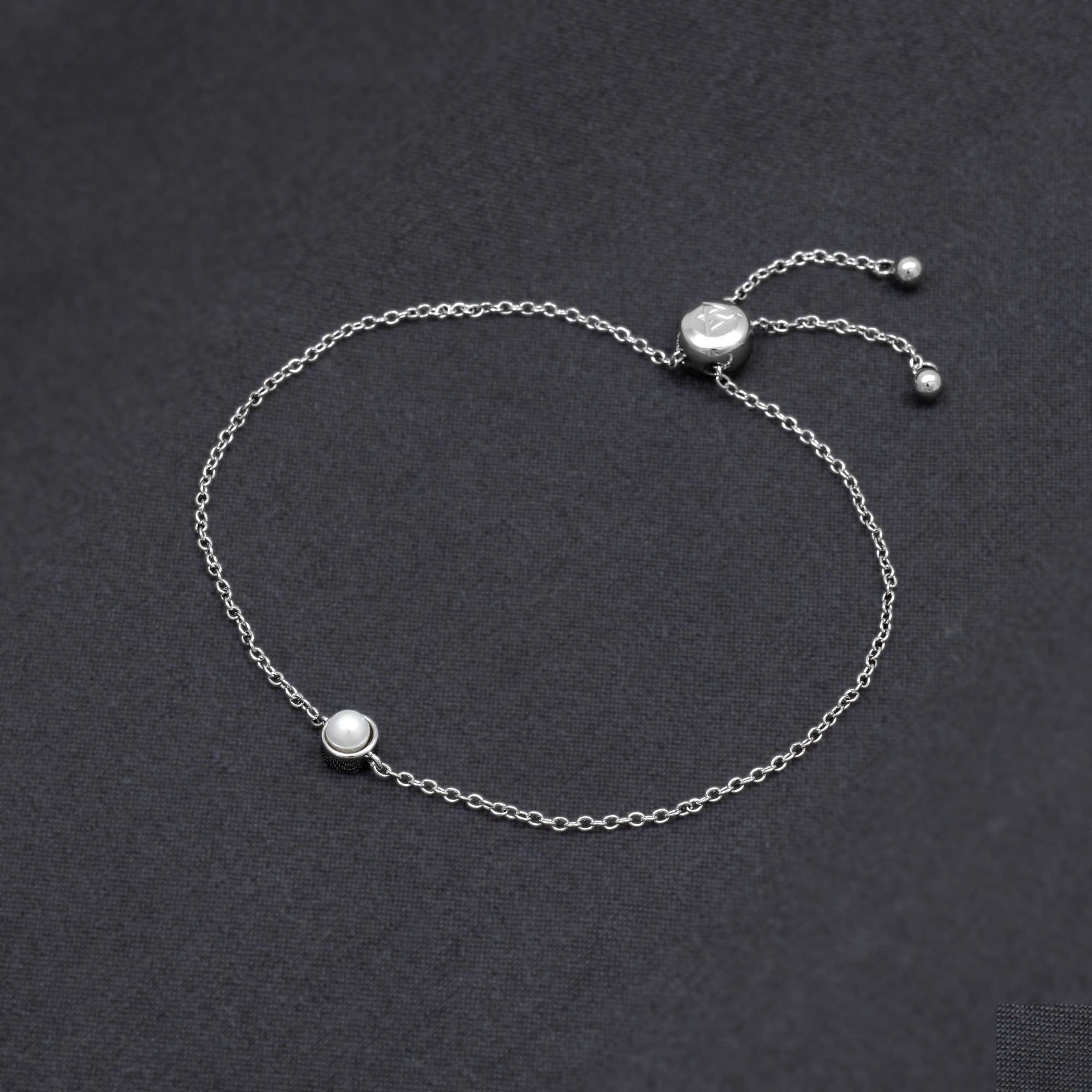 Delicate sterling silver bracelet featuring a freshwater pearl on a fine adjustable chain, showcasing expert British craftsmanship in a minimalist, elegant design.