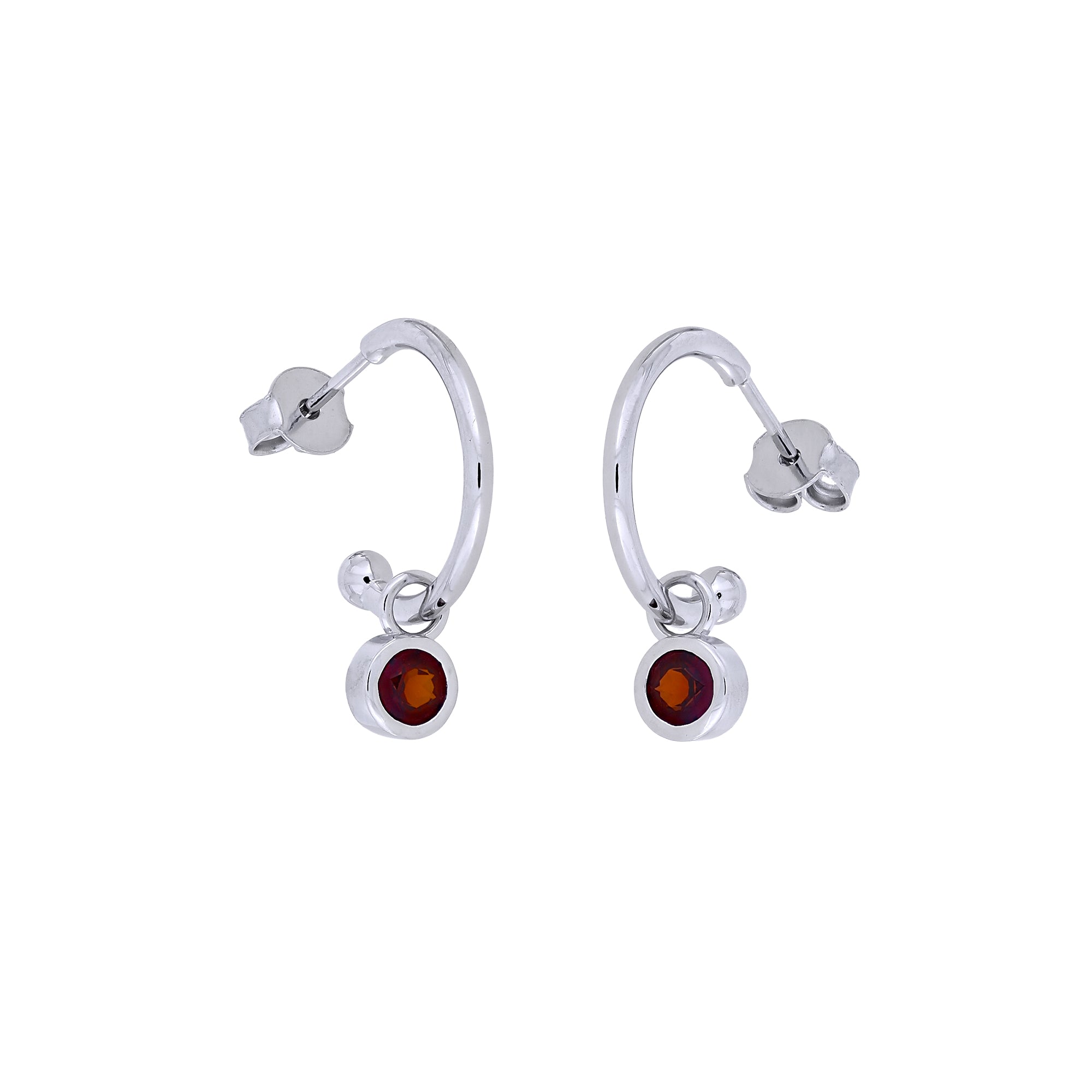 Pair of sterling silver hoop earrings featuring small garnet birthstones suspended with a minimalist, sculptural design, exemplifying expert British craftsmanship.