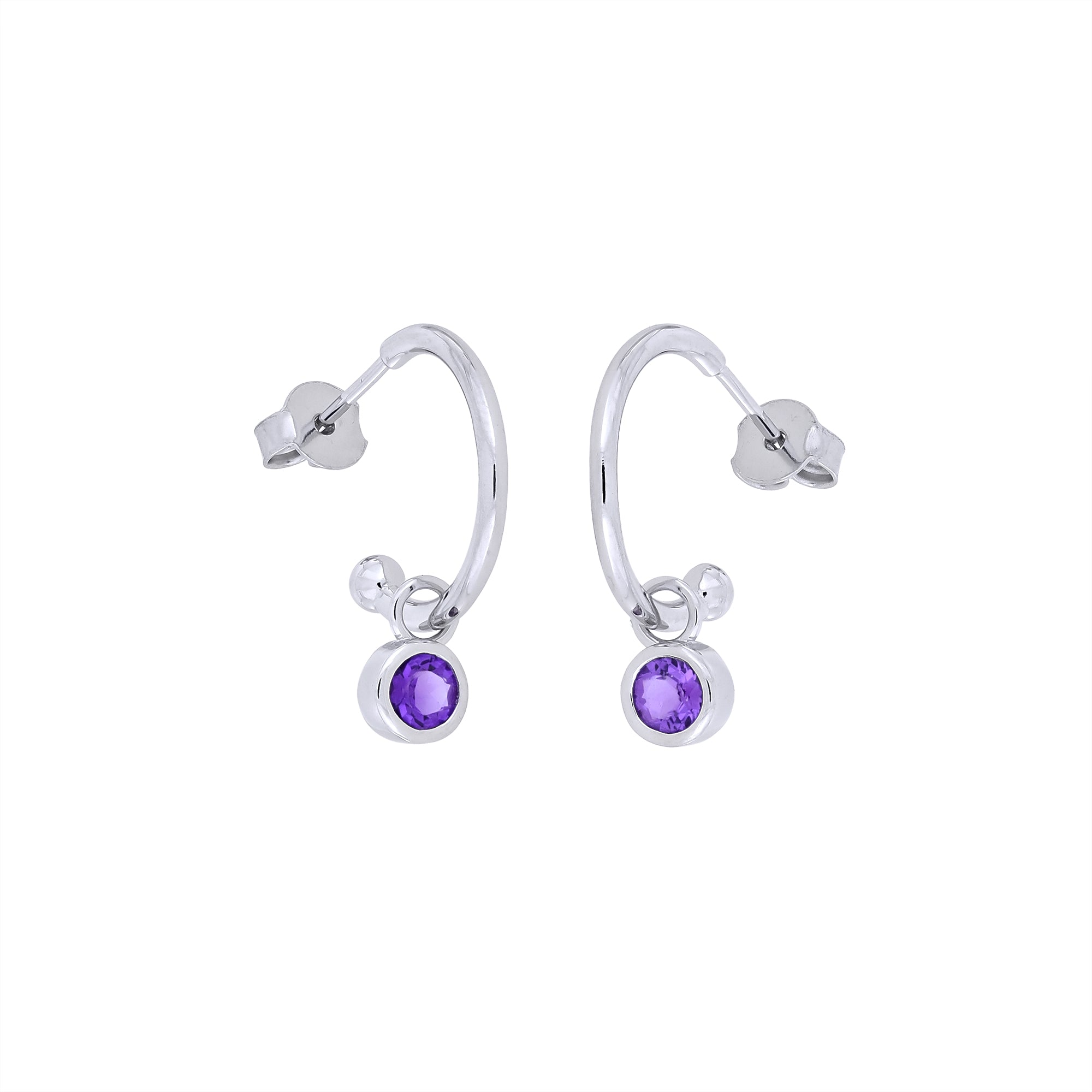 Sterling silver hoop earrings featuring a faceted amethyst birthstone charm, combining minimalist design with expert British craftsmanship for a subtle, elegant accessory.