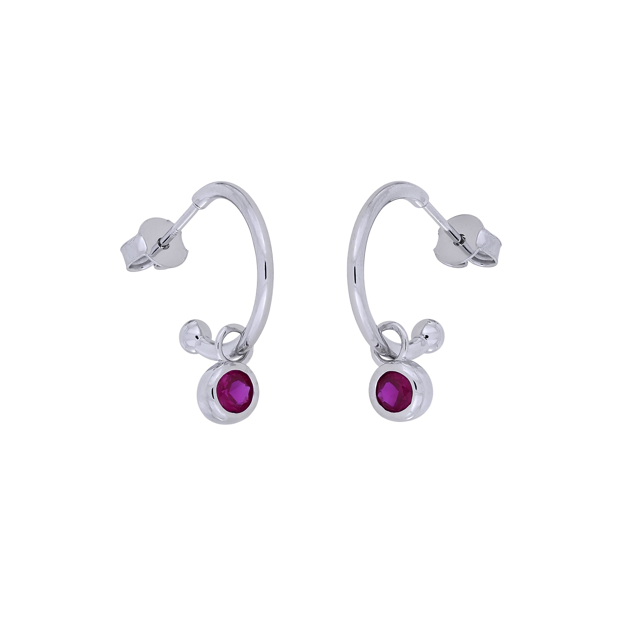 Delicate sterling silver hoop earrings featuring a deep red ruby birthstone charm, combining modern design with expert British craftsmanship by Azendi.