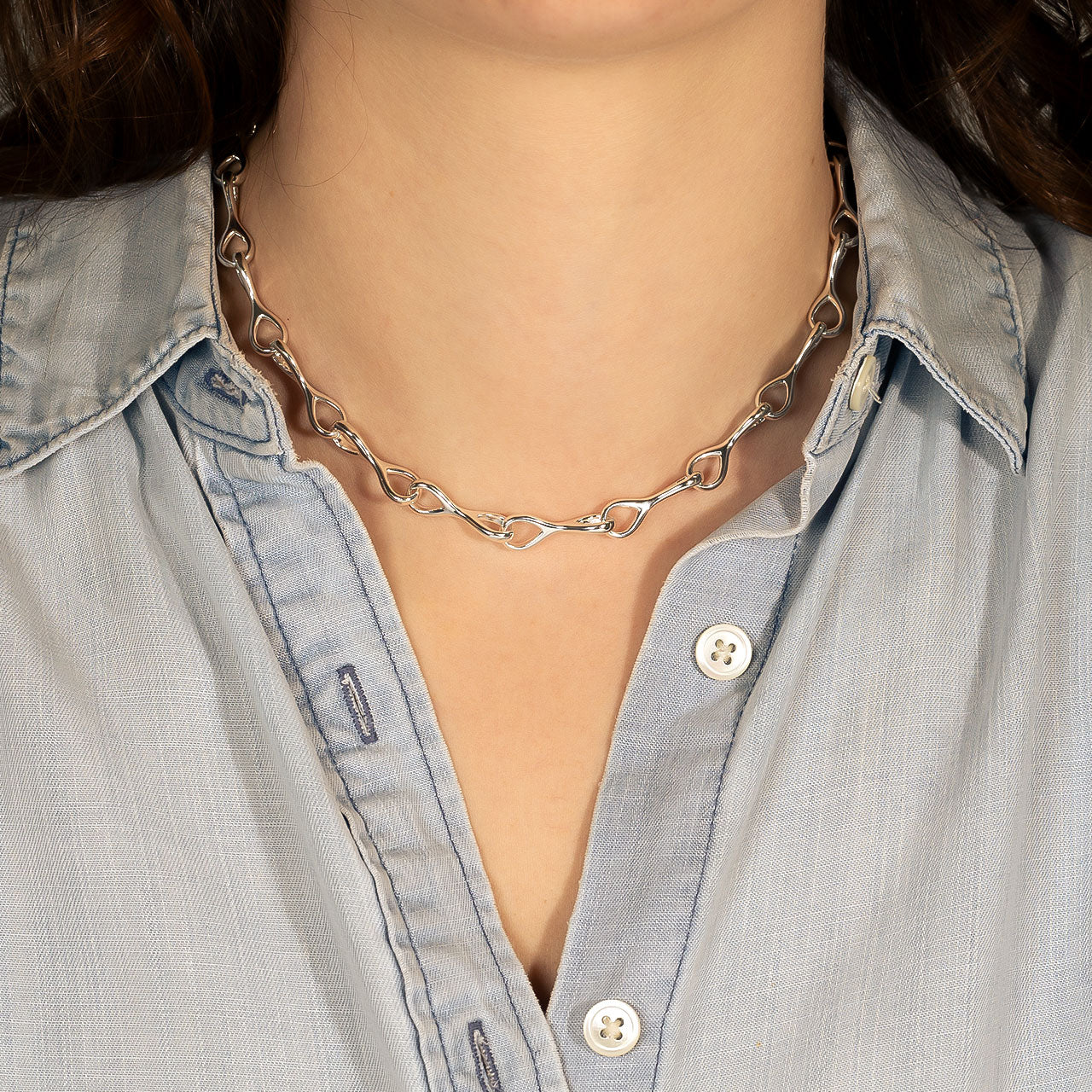 Polished sterling silver necklace featuring interlocking teardrop-shaped links with a sleek, sculptural design, offering refined elegance in contemporary silver jewellery.