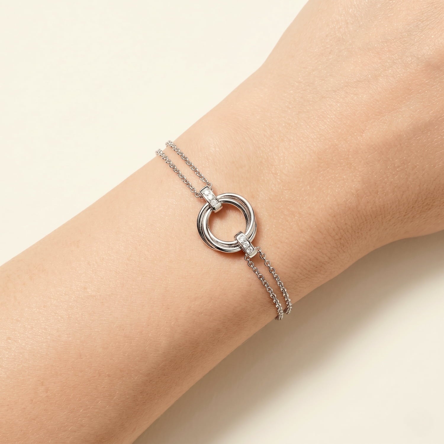 A sterling silver bracelet featuring an intertwined love knot centerpiece accented with lab-grown diamonds, crafted for refined contemporary elegance, modelled on the wrist.