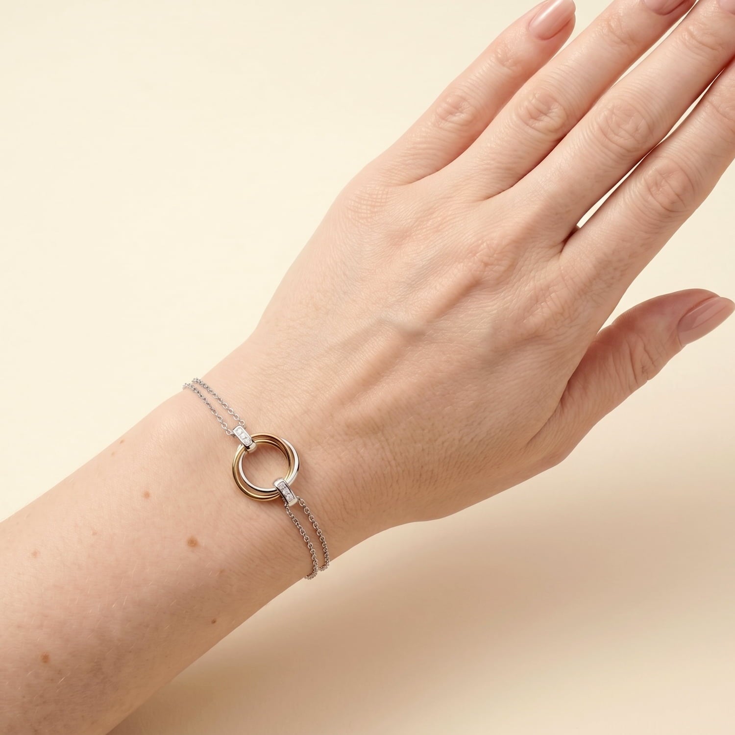 Adjustable mixed vermeil bracelet featuring an intertwined love knot centrepiece accented with lab-grown diamonds, crafted for refined contemporary elegance, worn on the wrist.