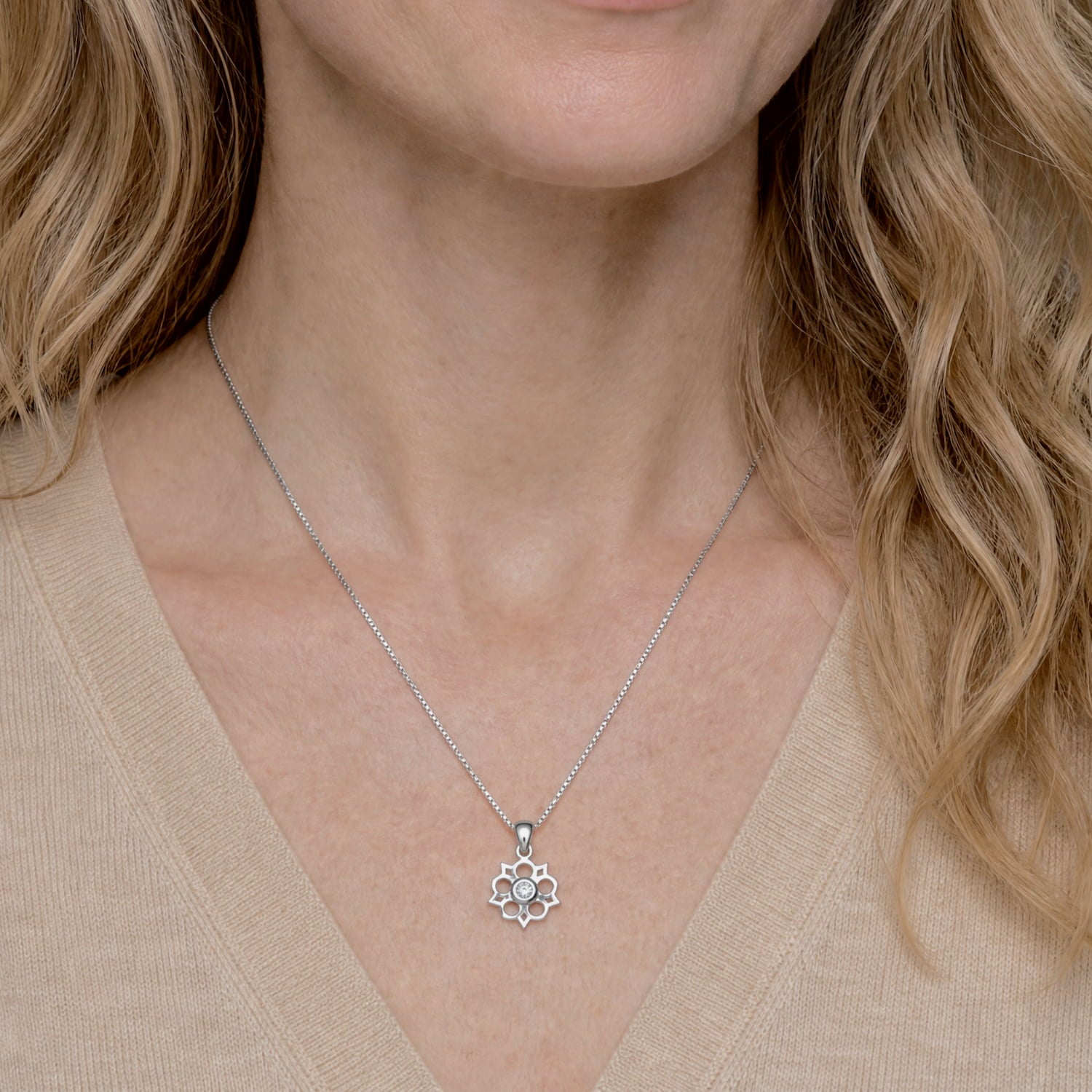 Model wears sterling silver Yorkshire rose pendant featuring a 0.07 carat lab-grown diamond at the centre, suspended on a delicate fine chain with sculptural elegance.