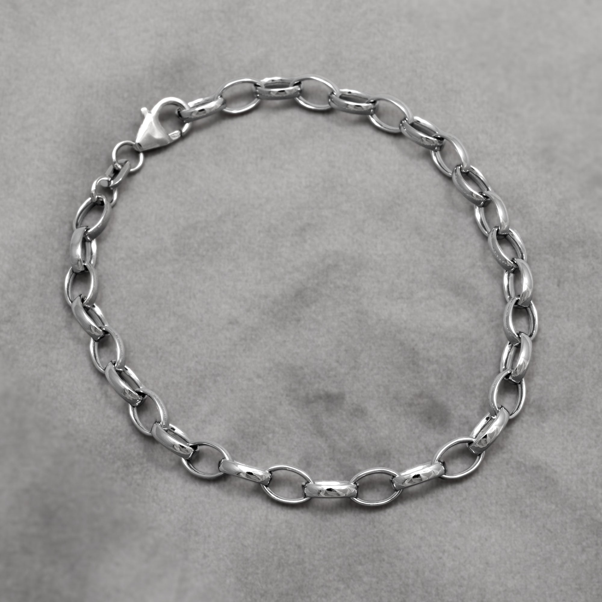 Classic and elegant sterling silver belcher chain bracelet on a grey background
