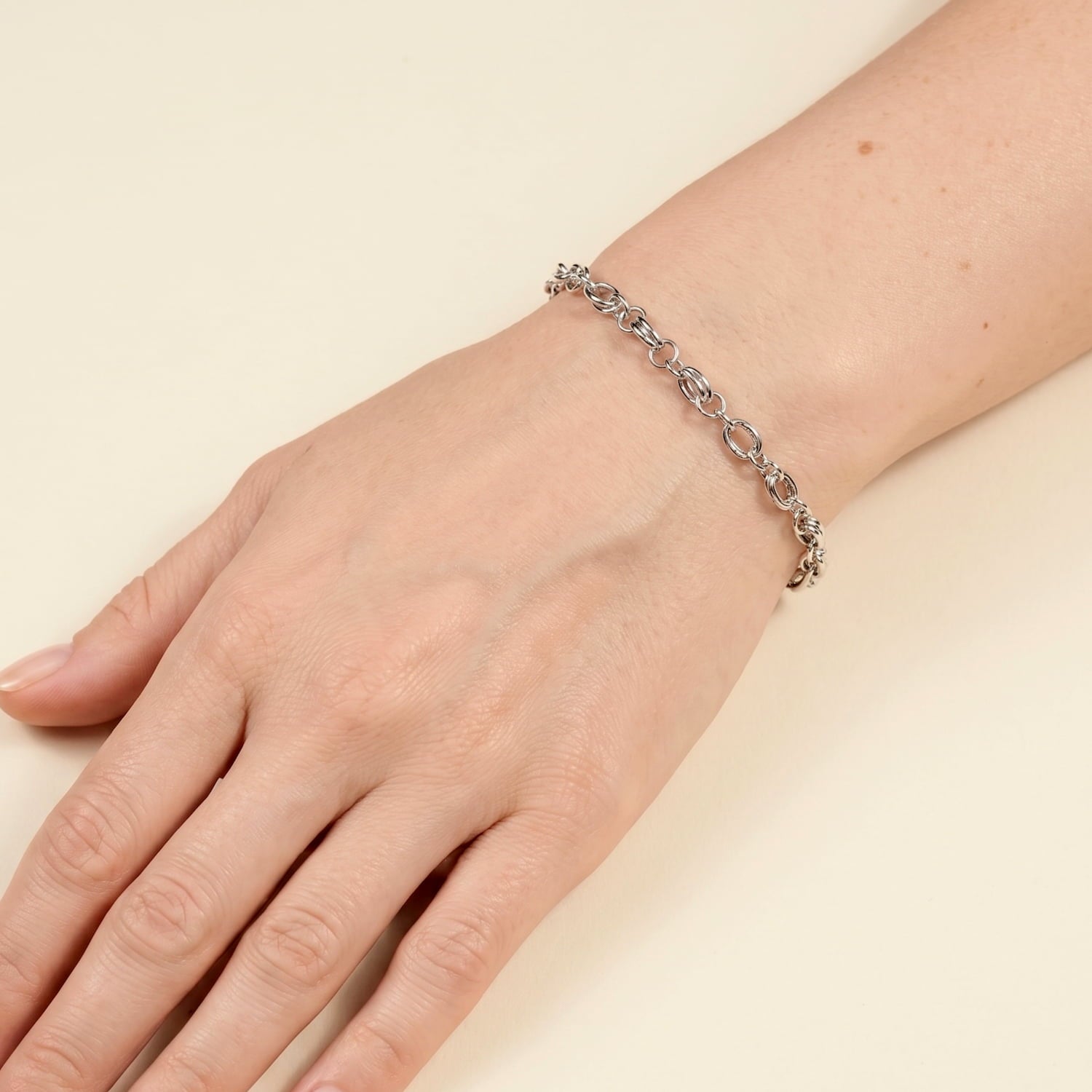 Sterling silver double twisted oval links chain bracelet modelled on a wrist.