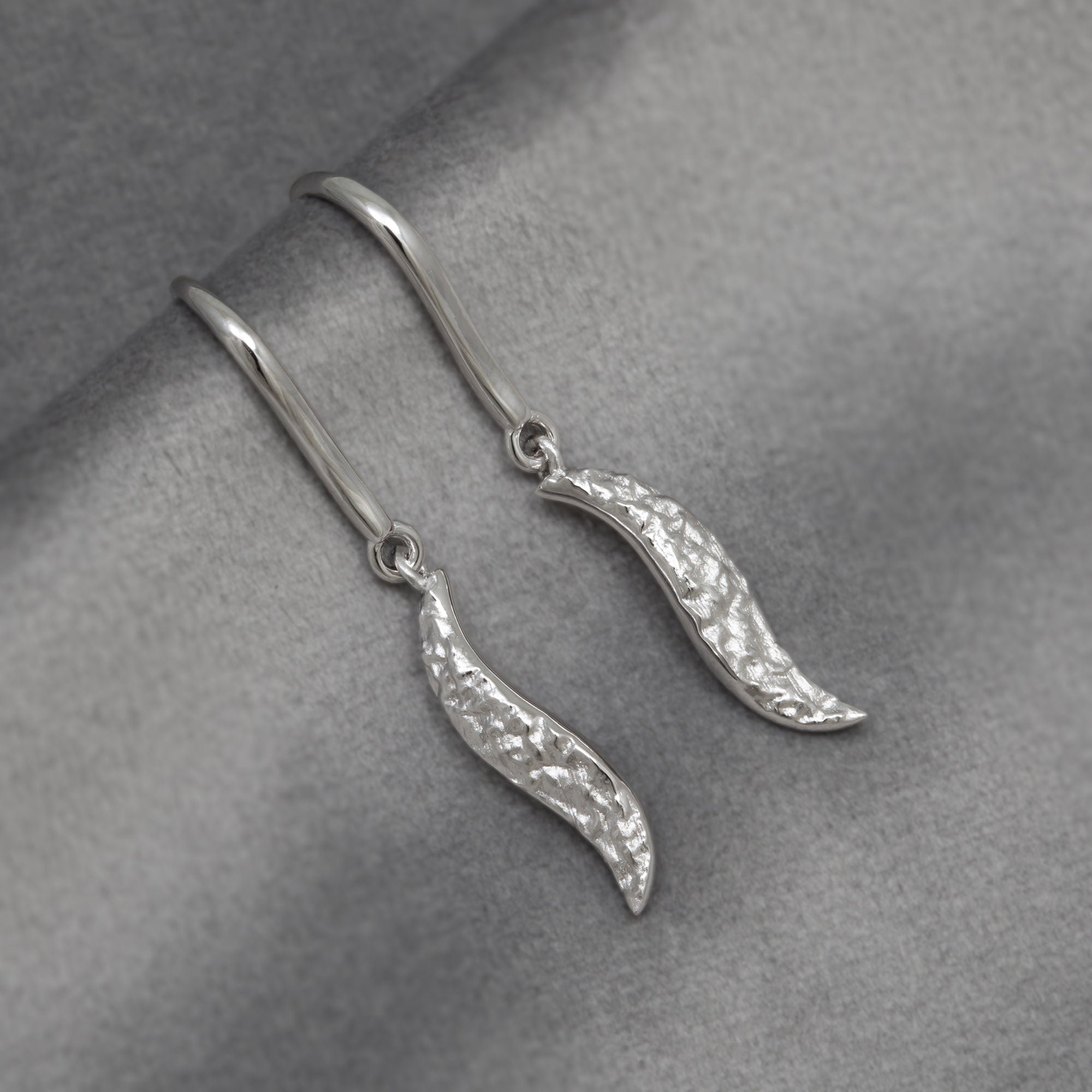 Silver textured drop earrings with a wavy design