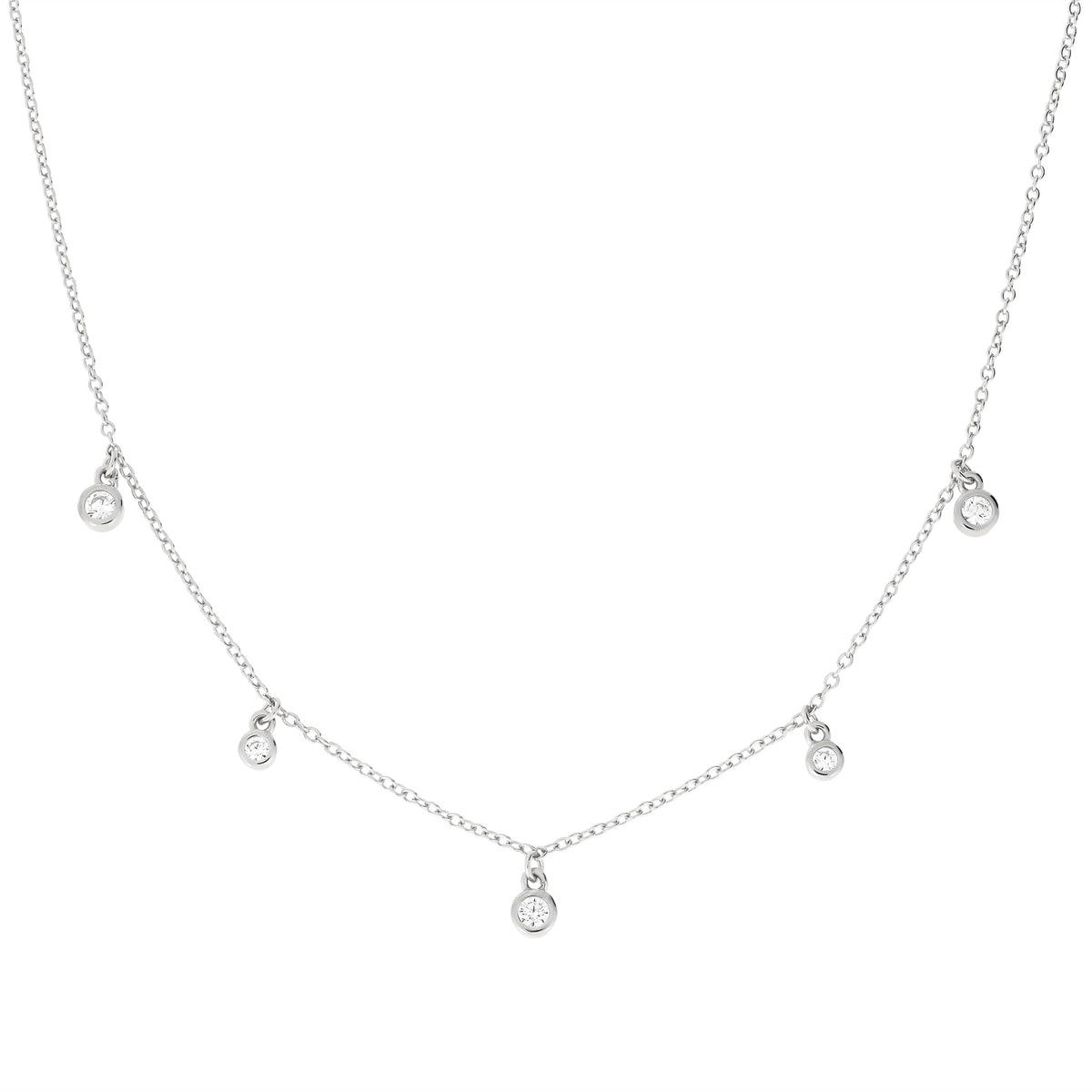 A delicate silver necklace featuring a fine chain with five small, evenly spaced round bezel-set clear cubic zirconia stones, displayed on a solid white background.