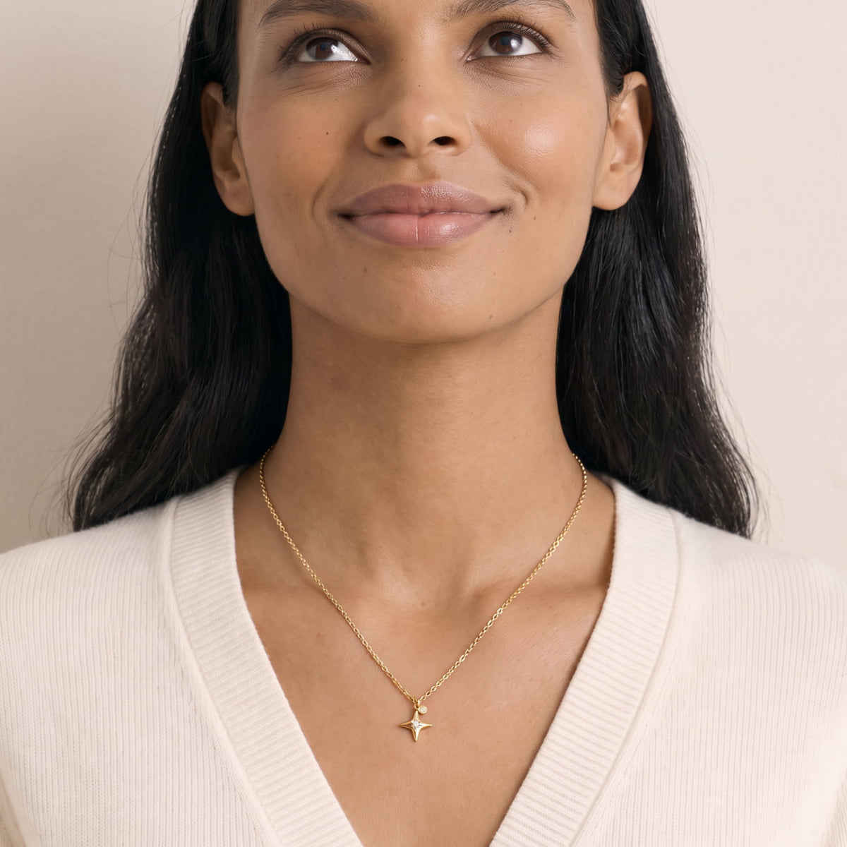 Model wears a gold vermeil necklace featuring a four-pointed star pendant with lab grown diamonds.