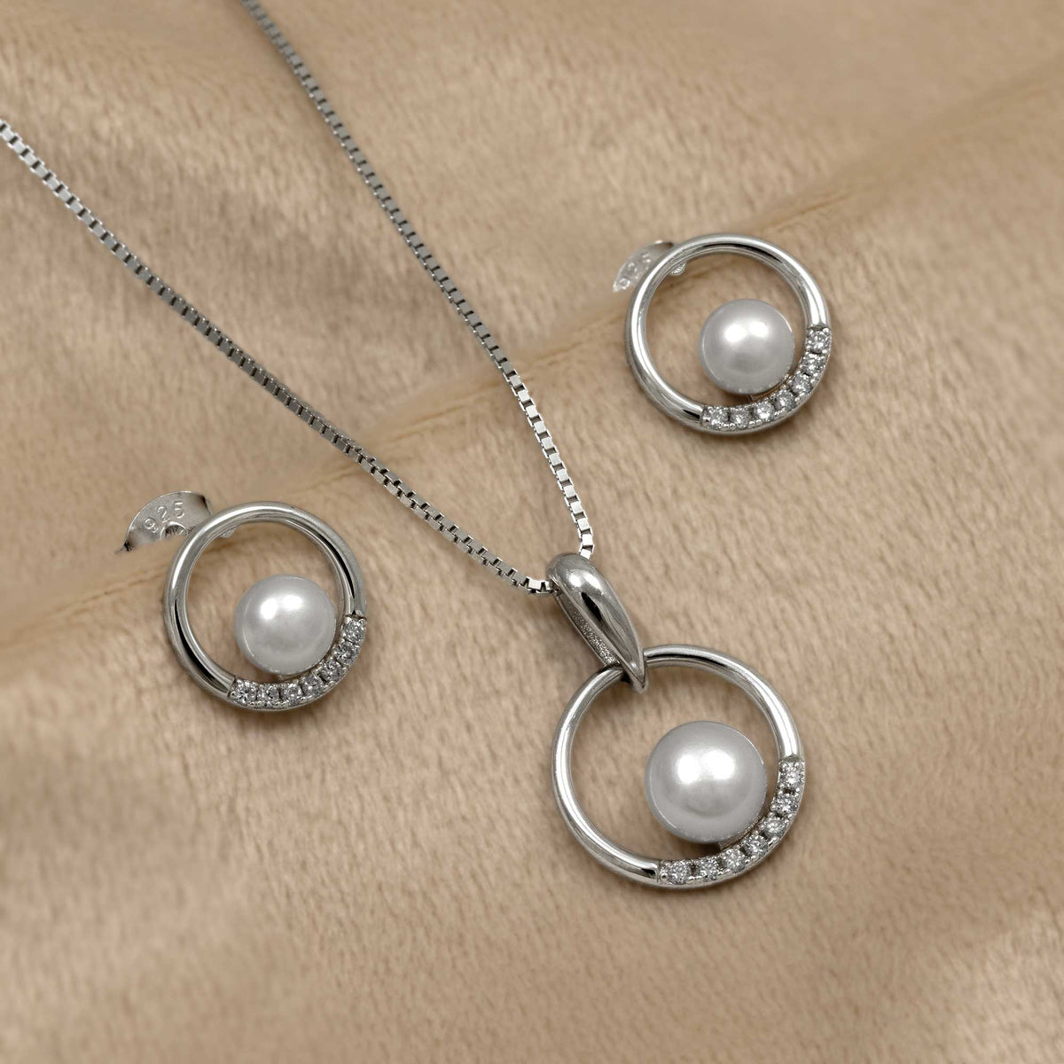 Pearl jewellery set with lab grown diamonds on a beige background