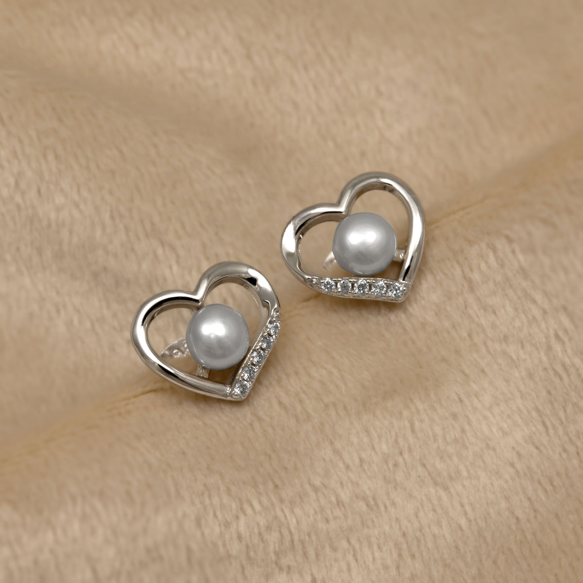 Sterling silver heart shaped stud earrings with pearls and lab grown diamonds.