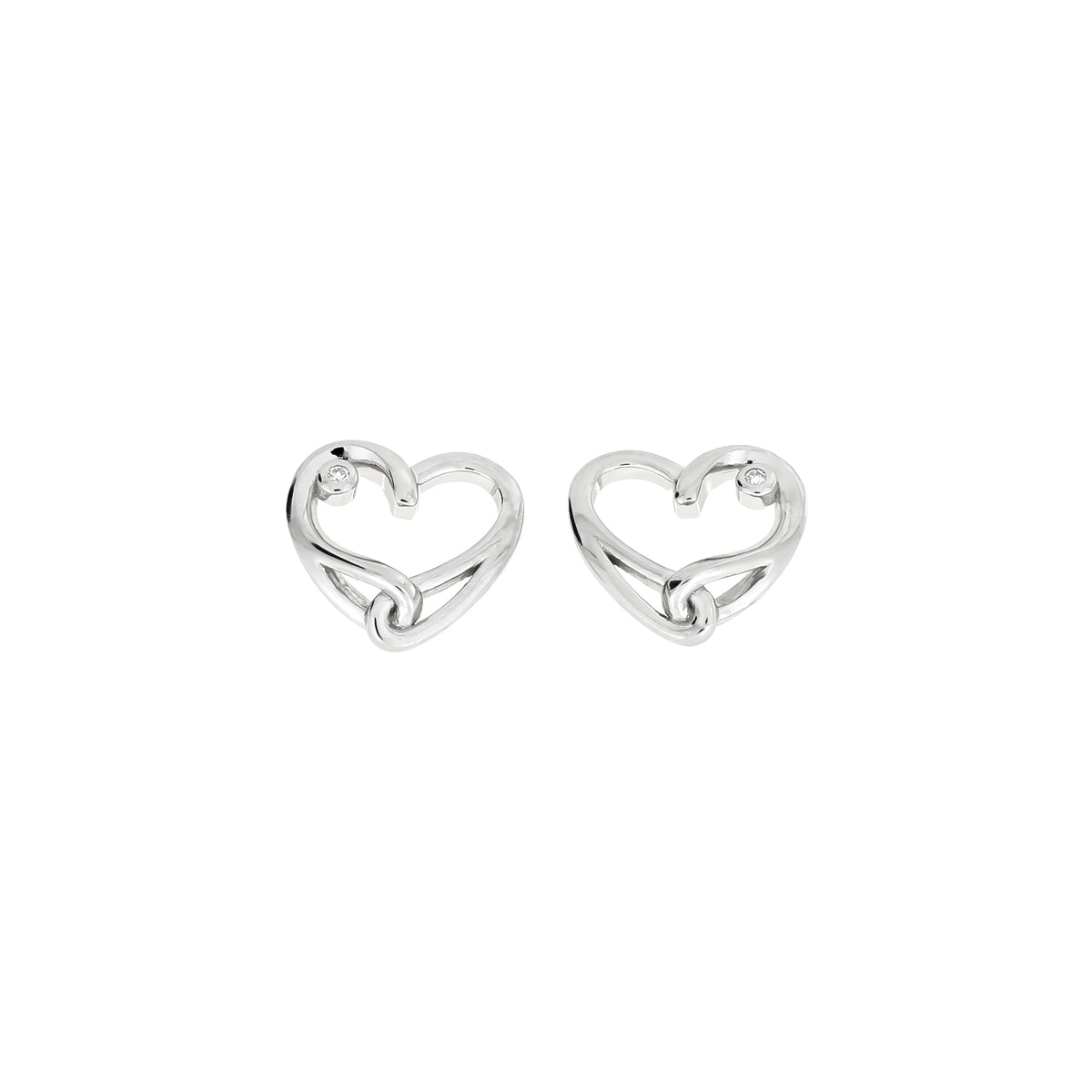 A pair of polished silver heart-shaped stud earrings with a lab grown diamond accent, displayed on a clean white background.