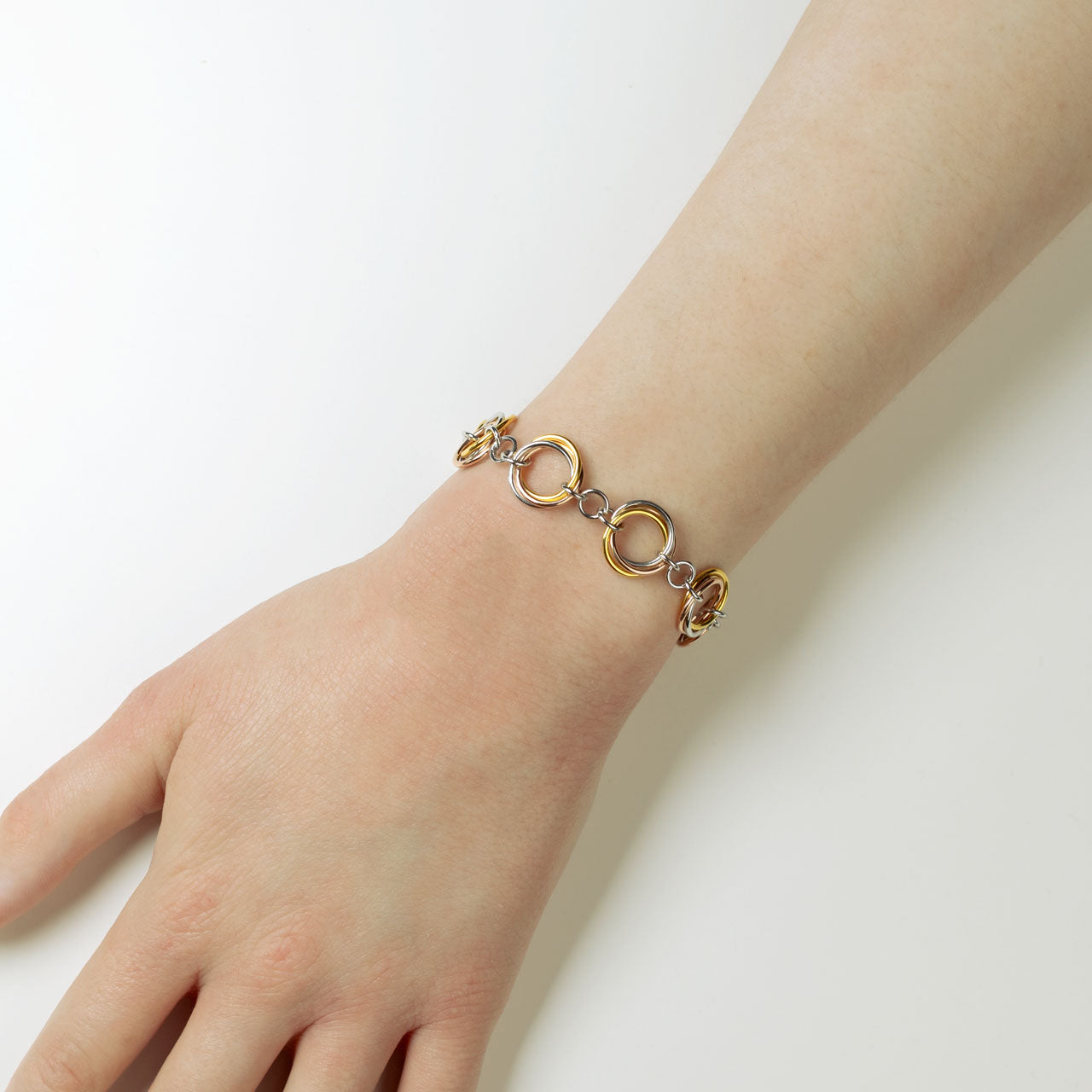Sterling silver bracelet featuring intertwined open circular links with a polished finish, combining sculptural elegance and contemporary British design.