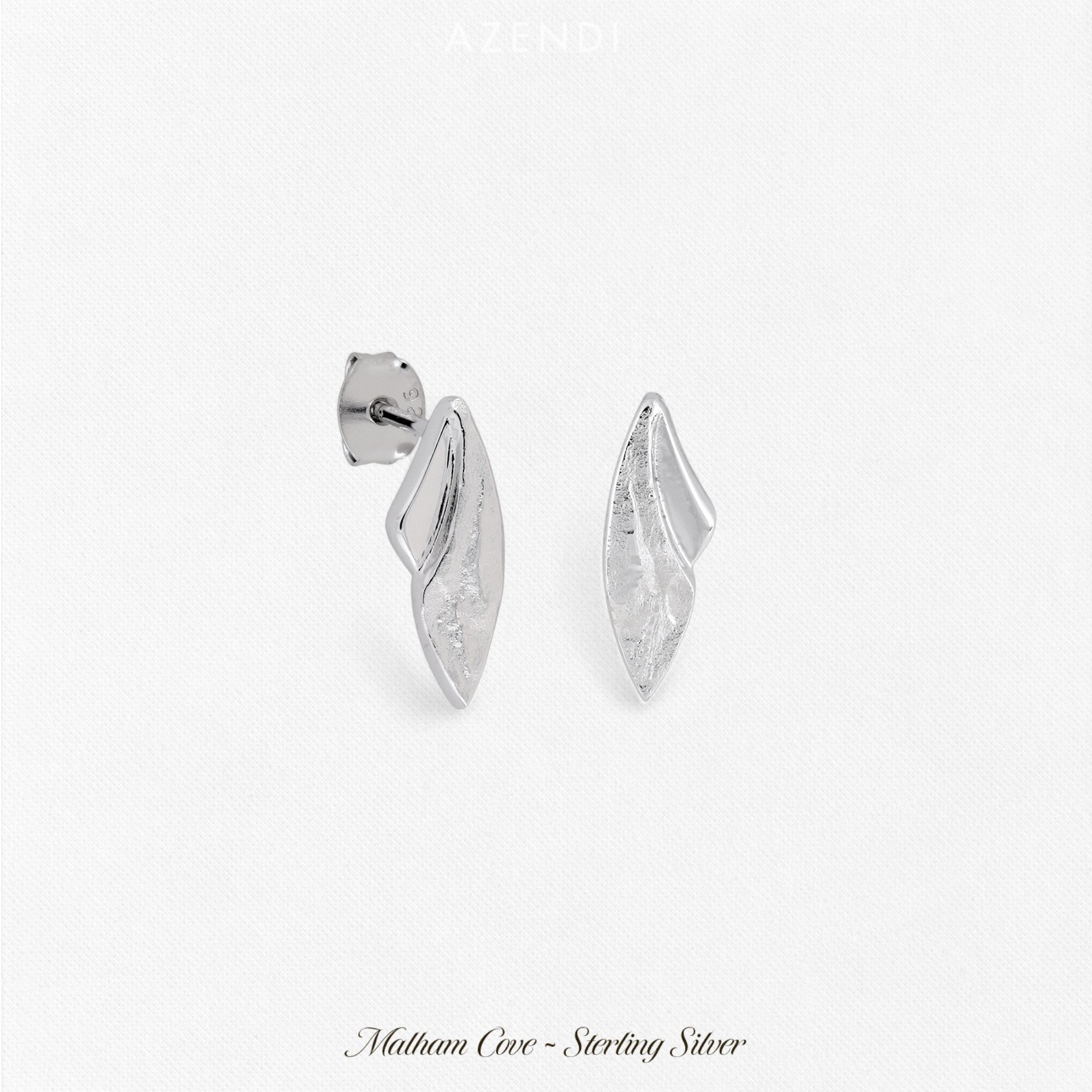 Pair of curved sterling silver stud earrings featuring a textured and polished finish, showcasing a sculptural and modern design in refined silver jewellery by Azendi.
