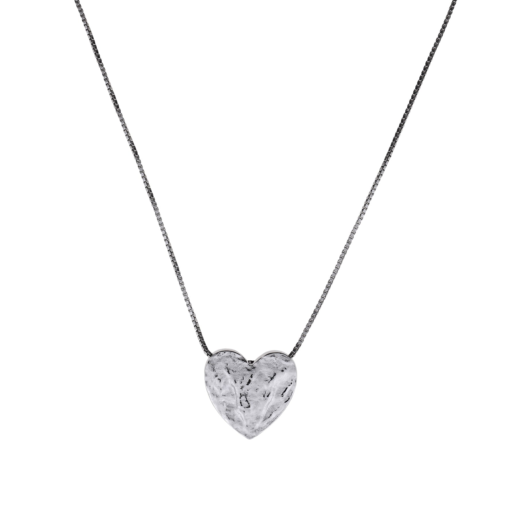 Sterling silver heart pendant with a textured surface on a delicate chain, showcasing a sculptural and refined design in contemporary silver jewellery.