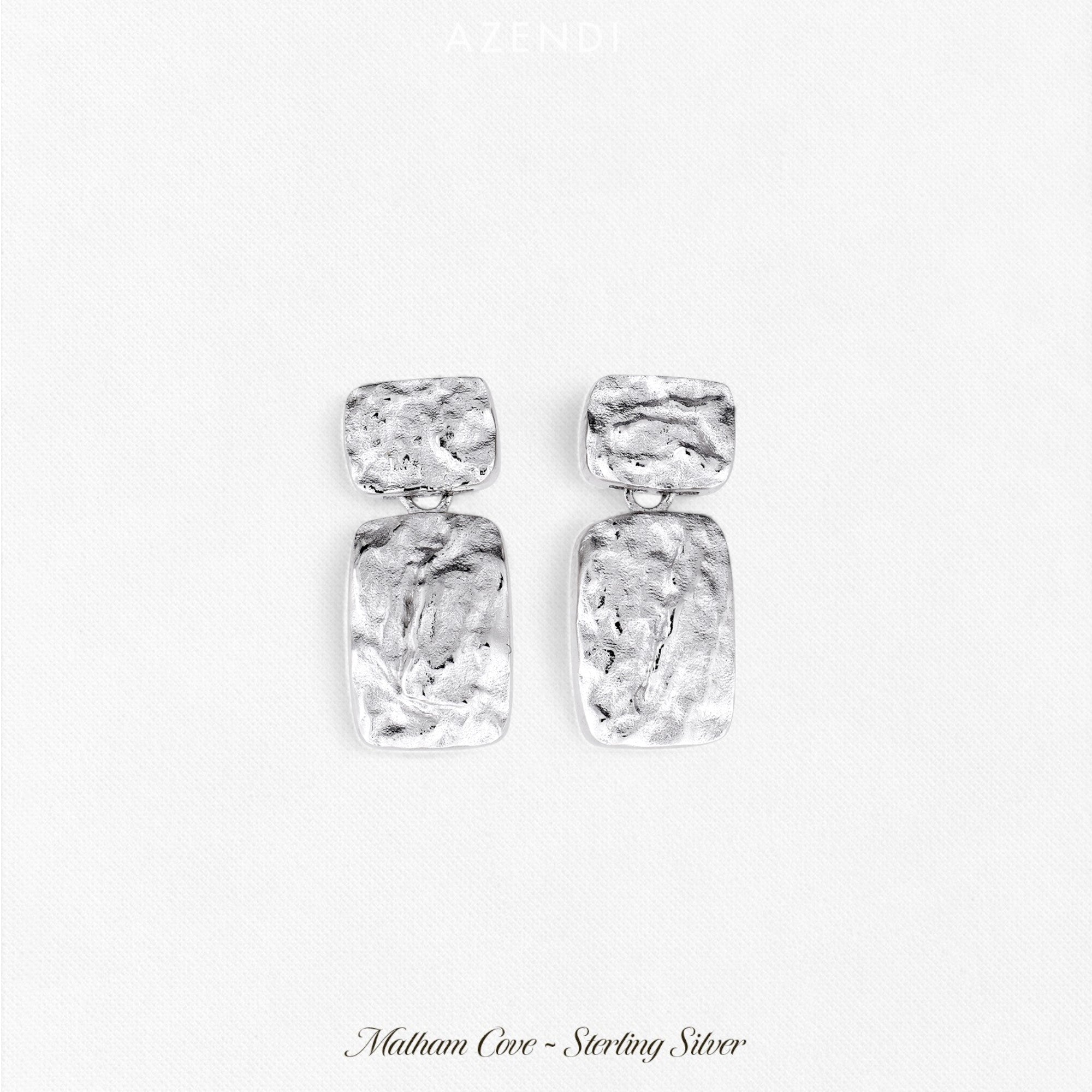 Sculptural sterling silver drop earrings featuring two textured rectangular shapes linked together, showcasing contemporary British silver jewellery design by Azendi.