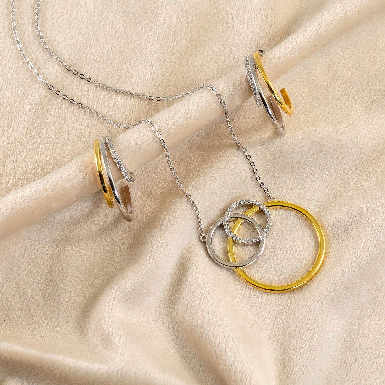 Sterling silver necklace featuring three interlocking circles in silver and gold vermeil, combining sculptural form with sophisticated contemporary design.