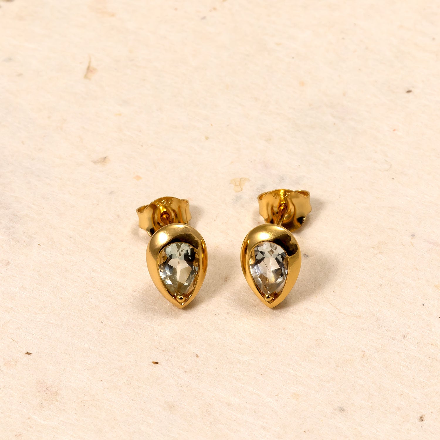 Pair of gold vermeil stud earrings featuring teardrop-shaped green amethyst gemstones set in a polished, sculptural frame for a refined look.