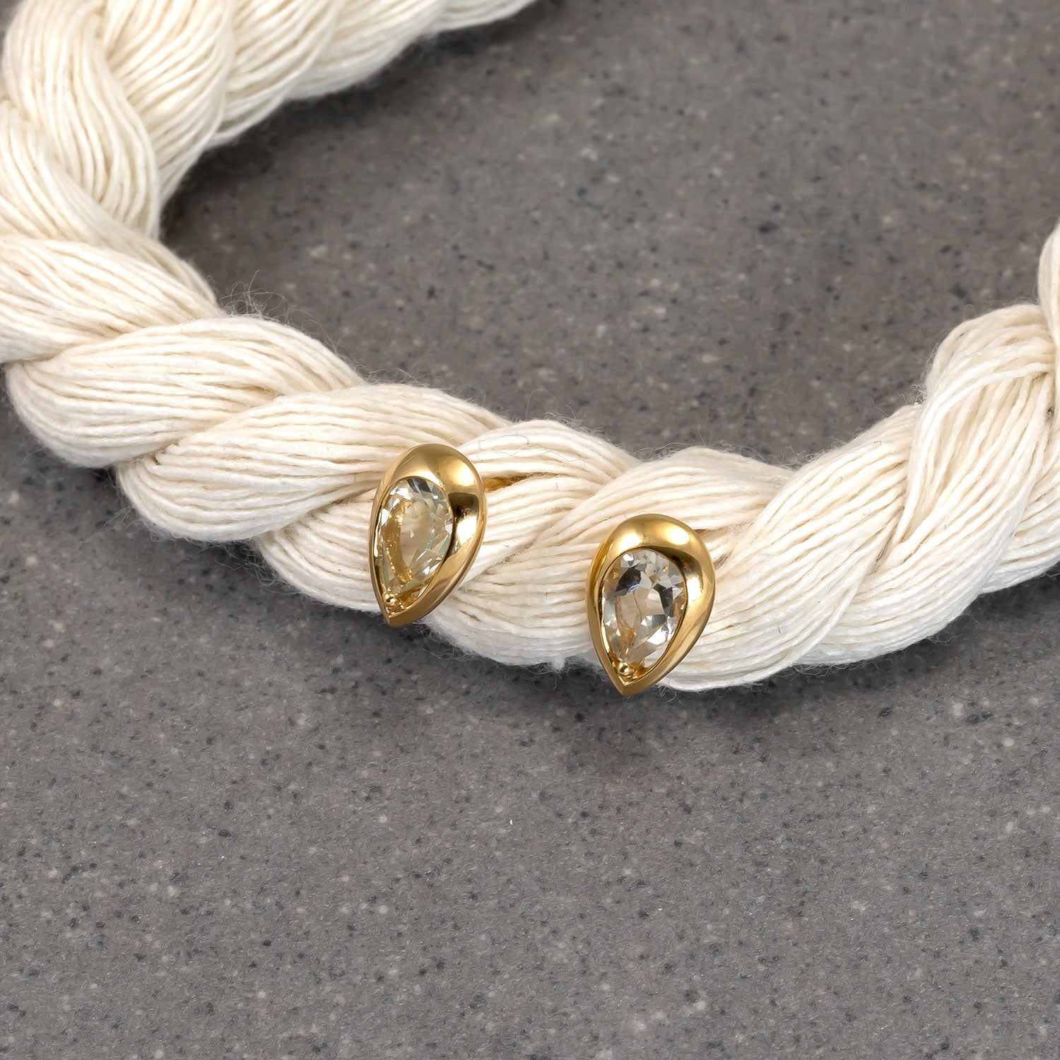 Pair of gold vermeil earrings featuring teardrop-shaped green amethyst gemstones set in a smooth, polished bezel for an elegant and refined silver jewellery look.