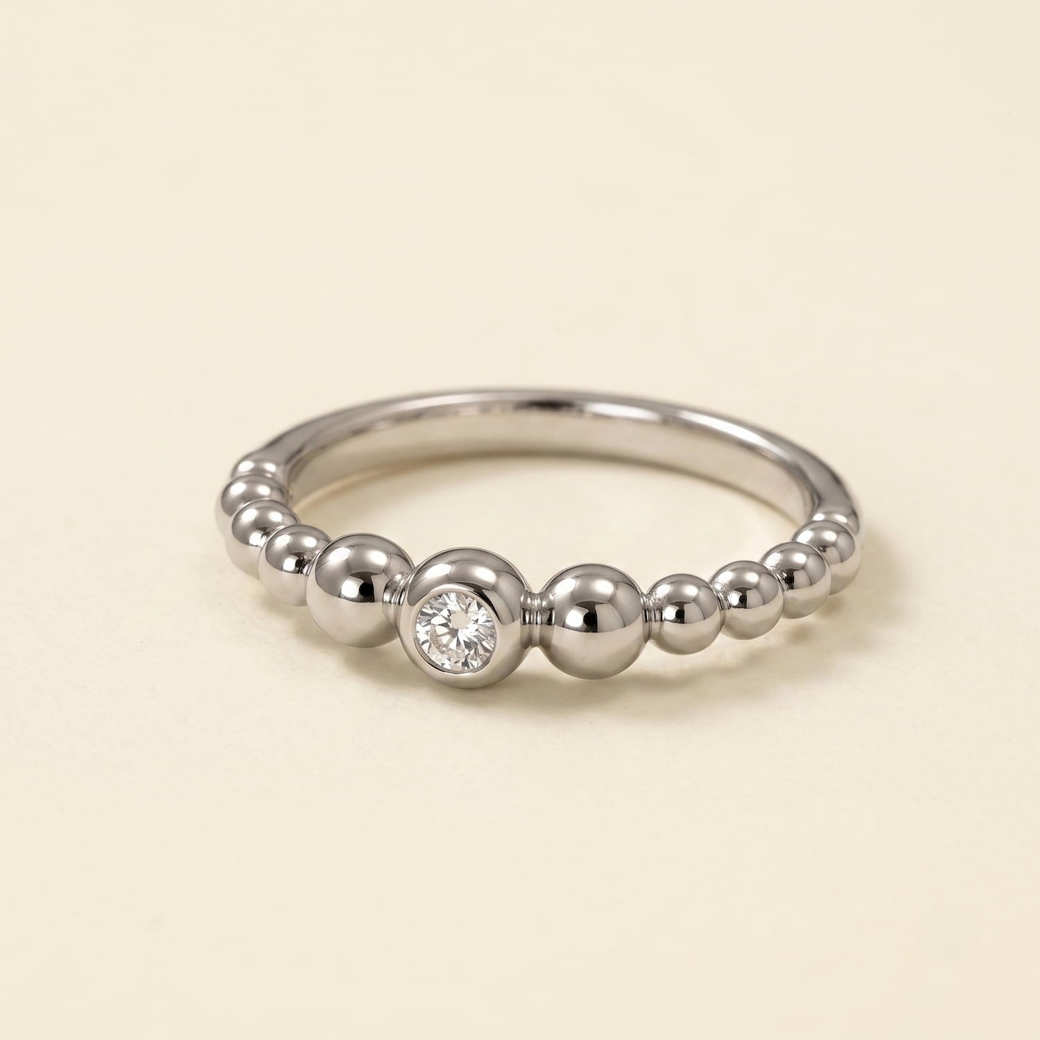 Sterling silver beaded ring featuring a clear cubic zirconia stone set in a sculptural design, exemplifying expert British craftsmanship and contemporary style.