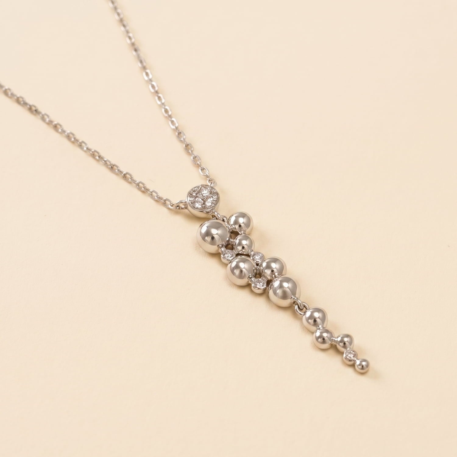 Sterling silver necklace featuring a sculptural beaded waterfall pendant accented with small cubic zirconia stones, combining contemporary design with refined elegance.