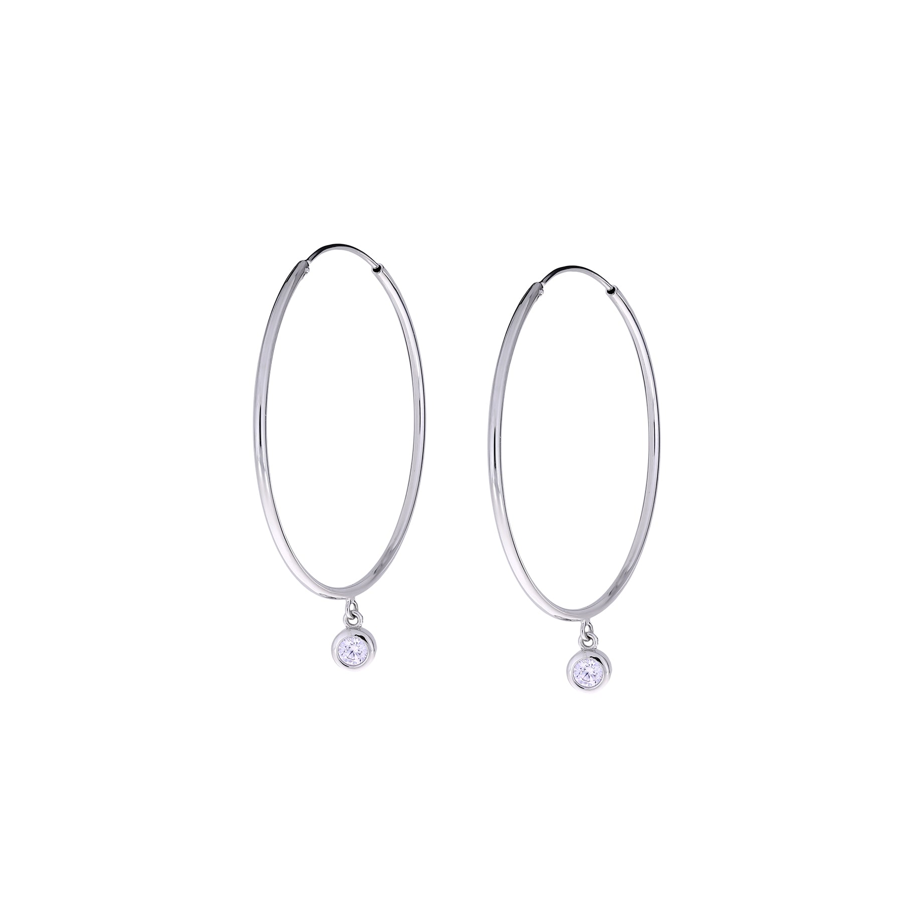 Slim sterling silver hoop earrings featuring a single brilliant-cut stone charm that adds subtle sparkle to a sleek and elegant silhouette in fine silver jewellery.
