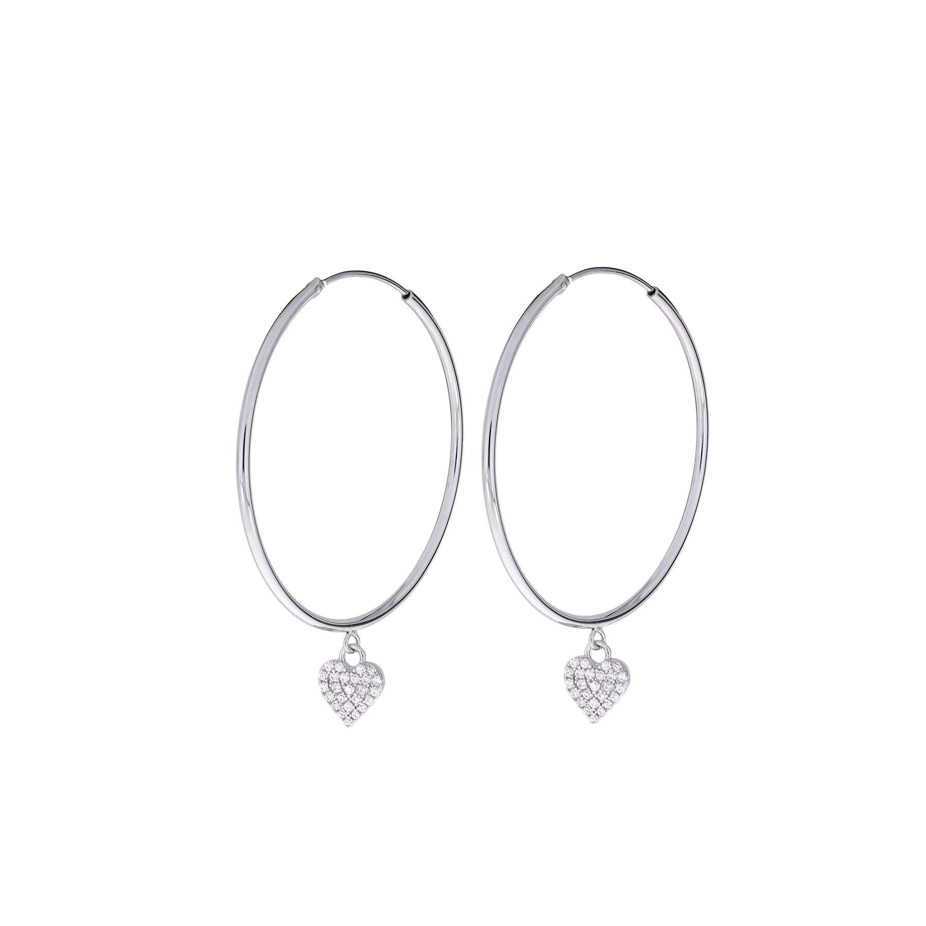 Slim sterling silver hoop earrings featuring delicately suspended heart-shaped charms with a polished finish, exemplifying refined modern silver jewellery design.