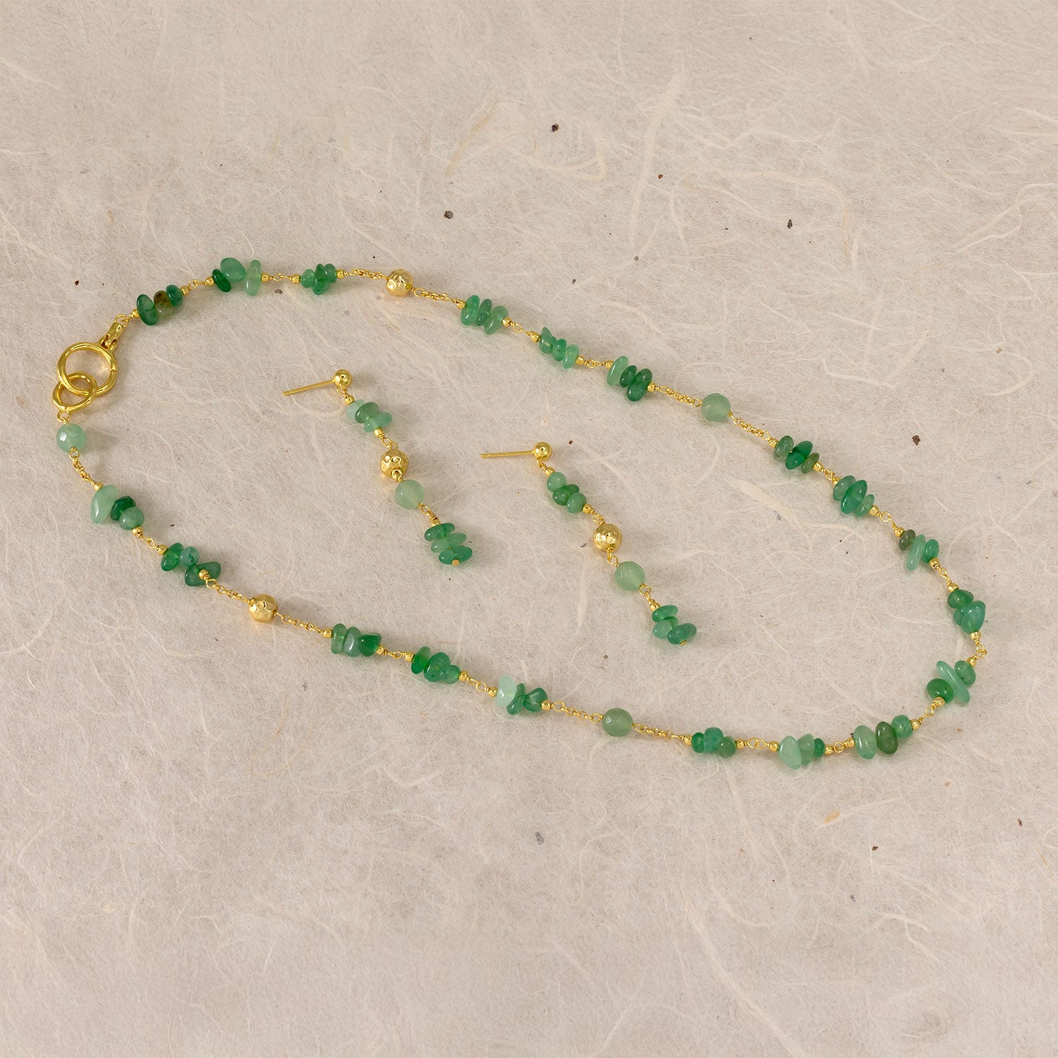 Delicate gold vermeil drop earrings featuring a string of irregular aventurine beads interspersed with small gold spheres, showcasing elegant contemporary design.