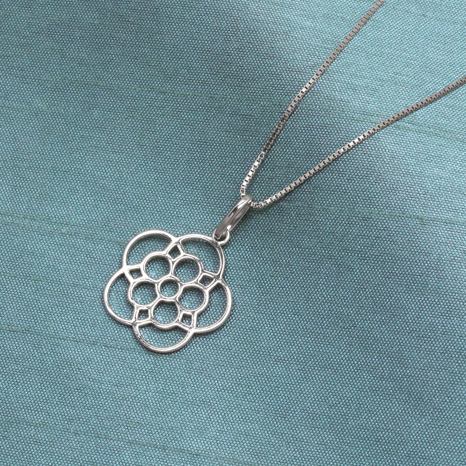 Delicate sterling silver pendant inspired by the Yorkshire rose, featuring a stylised openwork floral design suspended from a fine silver chain for refined everyday elegance.