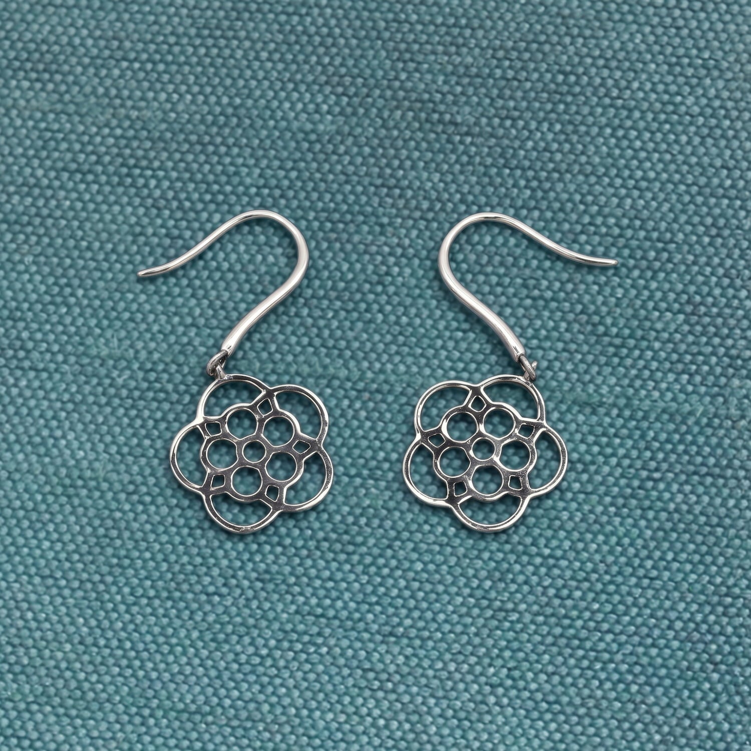 Delicately crafted sterling silver drop earrings featuring a stylised Yorkshire rose design with openwork petals, embodying refined and contemporary silver jewellery artistry.