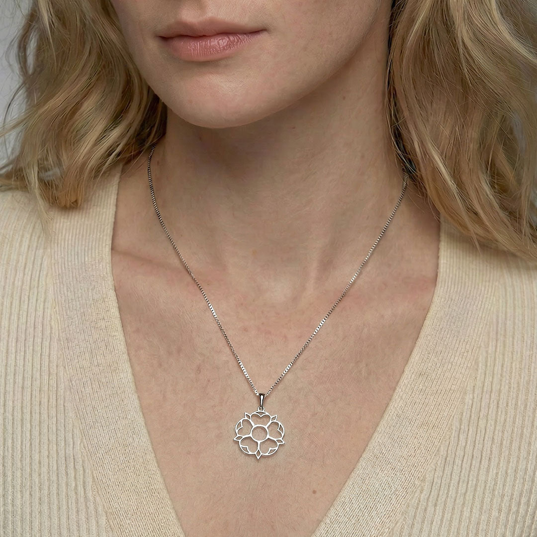 Delicate sterling silver pendant featuring an openwork Yorkshire rose design suspended from a fine chain, reflecting refined contemporary silver jewellery by Azendi.