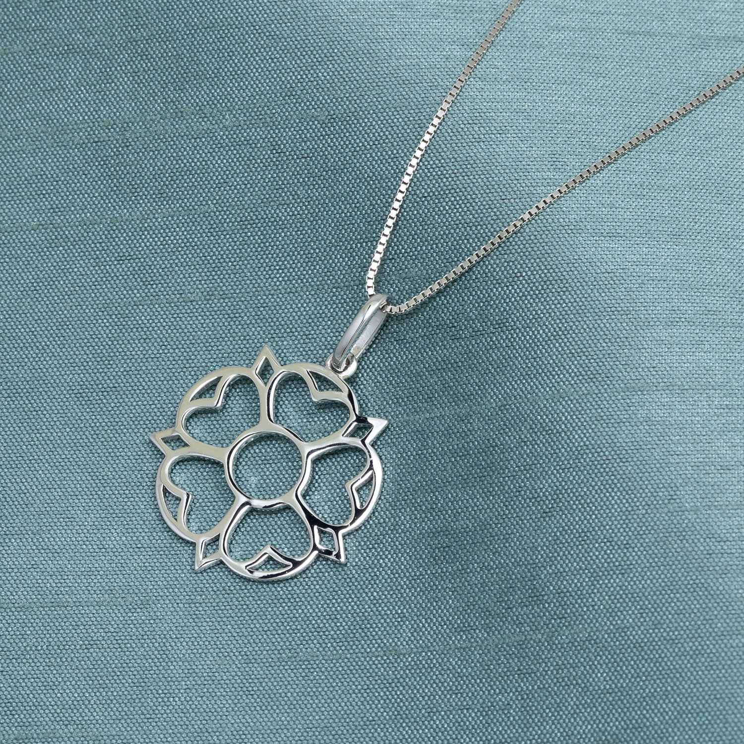 Delicate sterling silver pendant inspired by the Yorkshire Rose, featuring an openwork floral design suspended from a fine chain for timeless contemporary elegance.